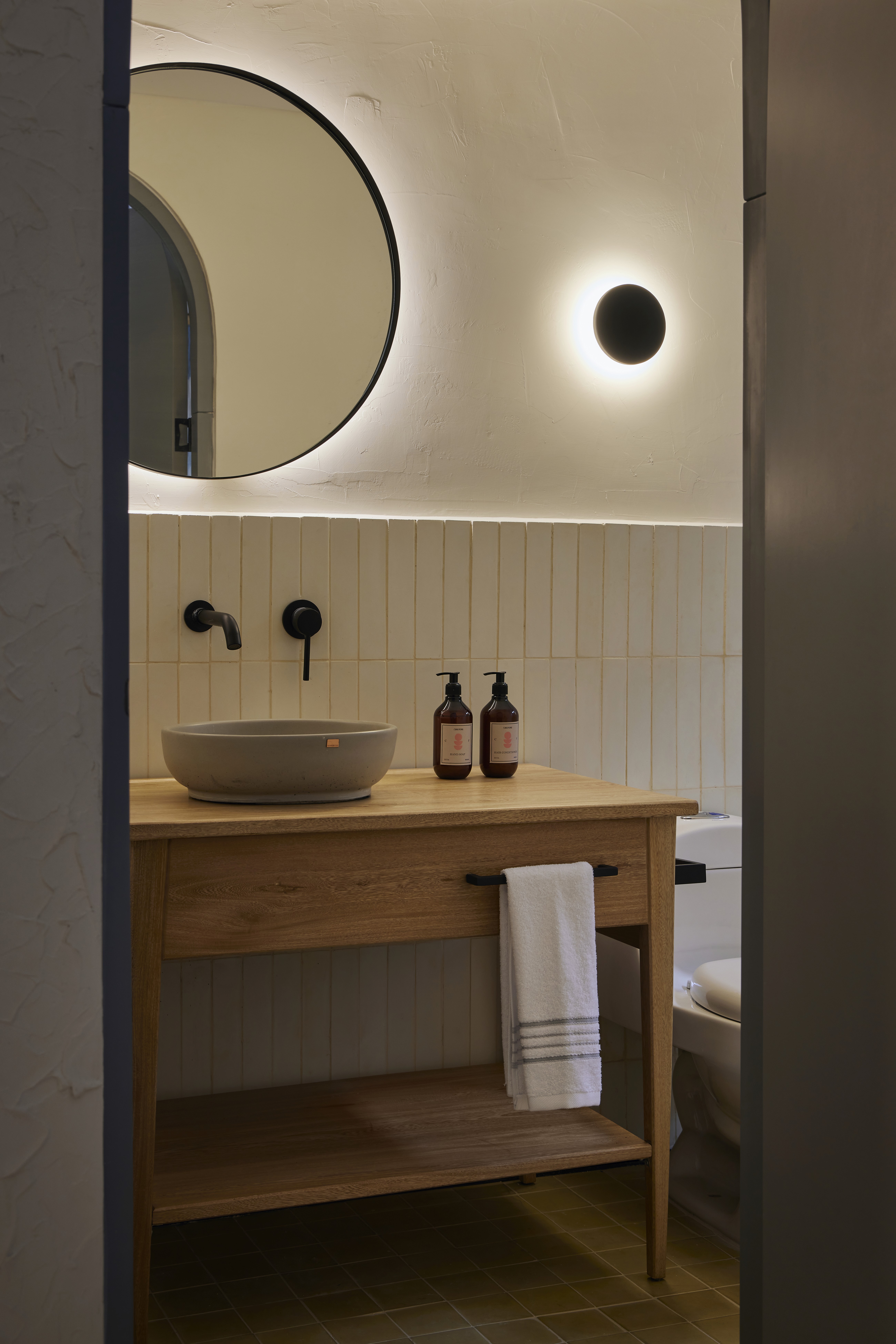 Double-height interior with flowing sculptural forms and warm raking light
