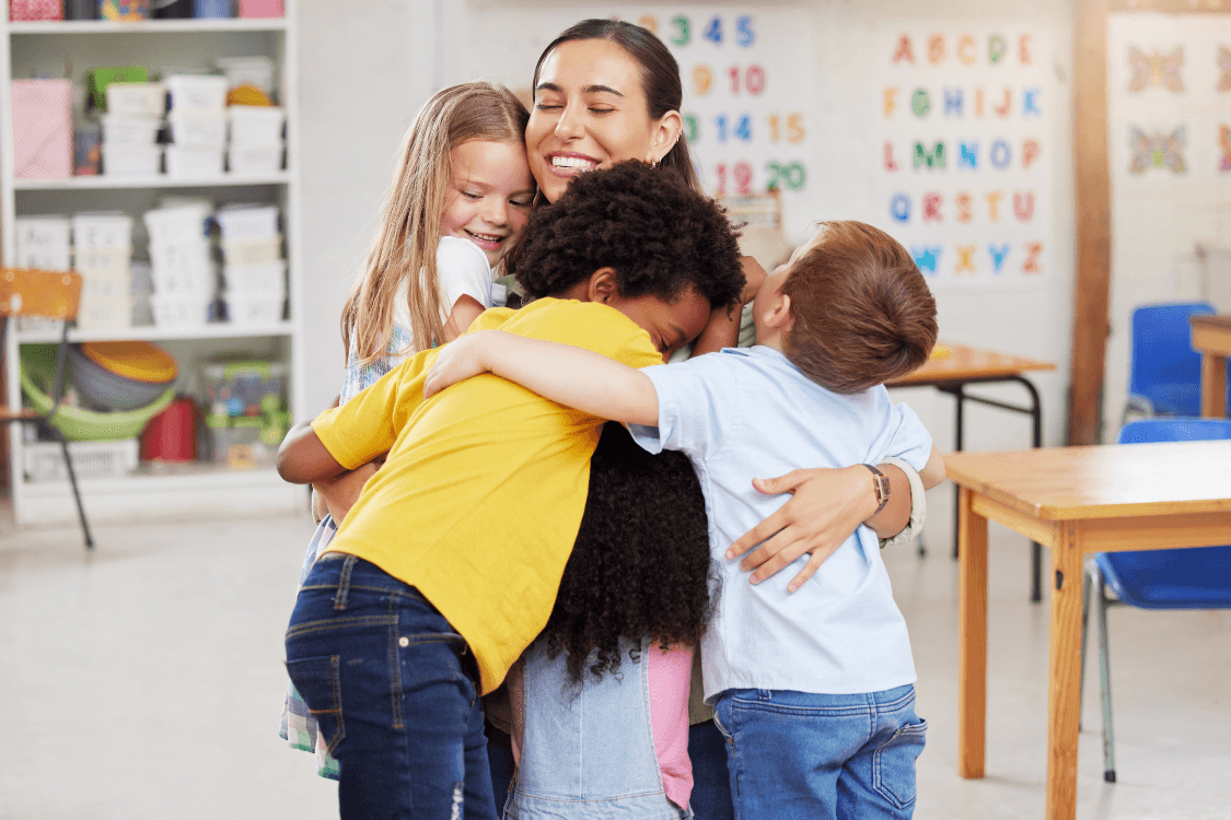 Woman smiling and relaxing in a bright classroom setting, showing the benefit of **less financial stress