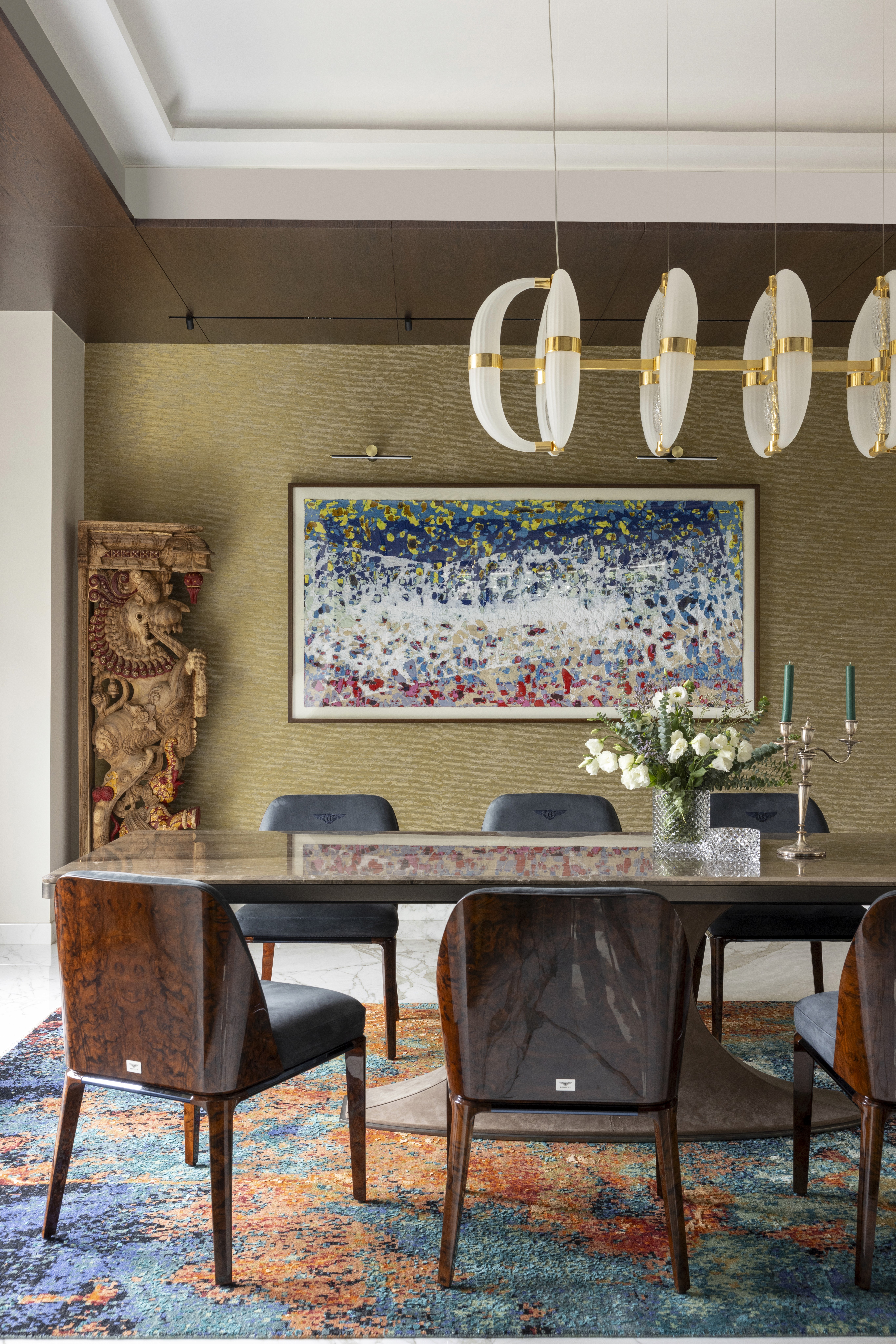 Sunlit beige living room with white sofa, artwork.