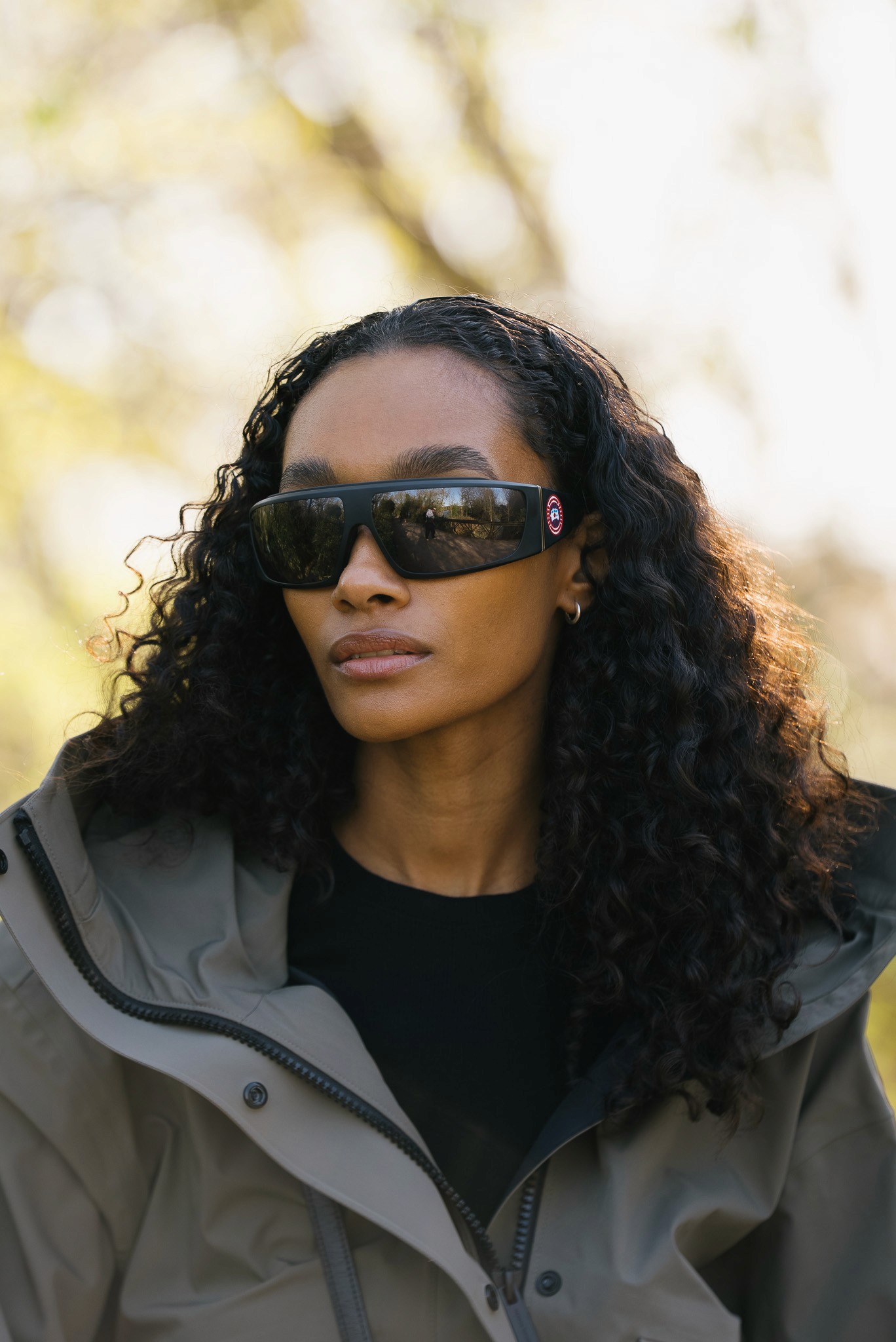 A woman in a straw hat stands in the grass