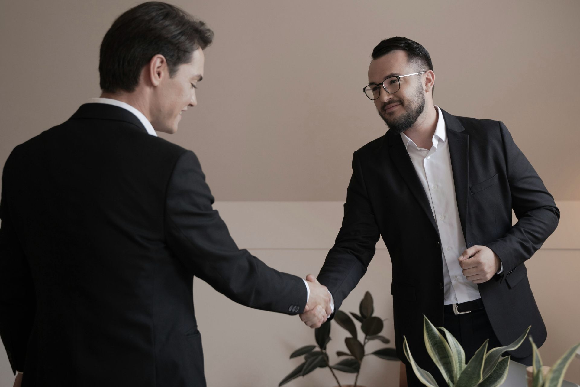 Two professional men shaking hands to seal an AI automation partnership