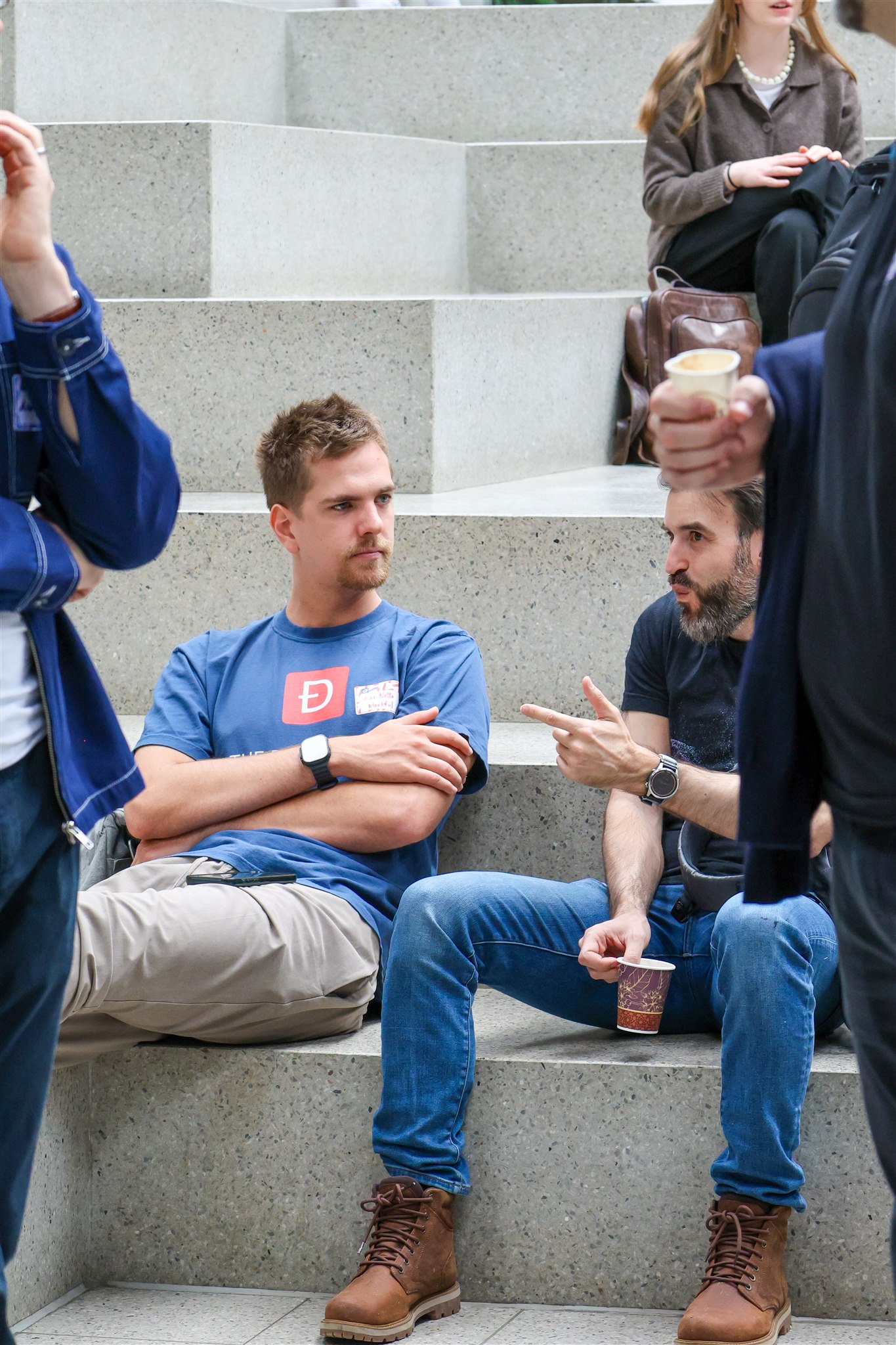 Attendees discussing on seating steps during EthereumZüri event in Zurich