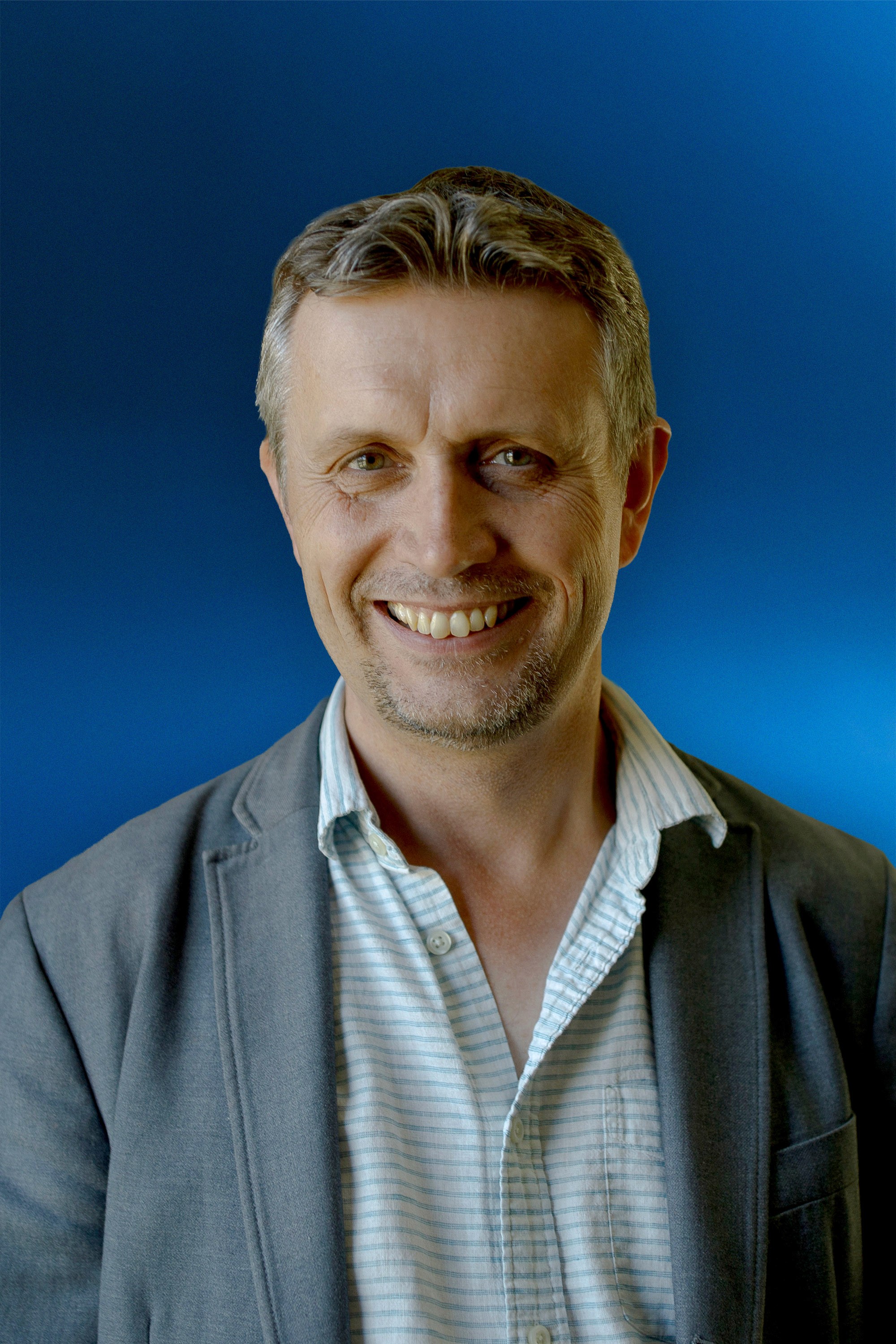 Portrait of a person in dark clothing speaking on a phone