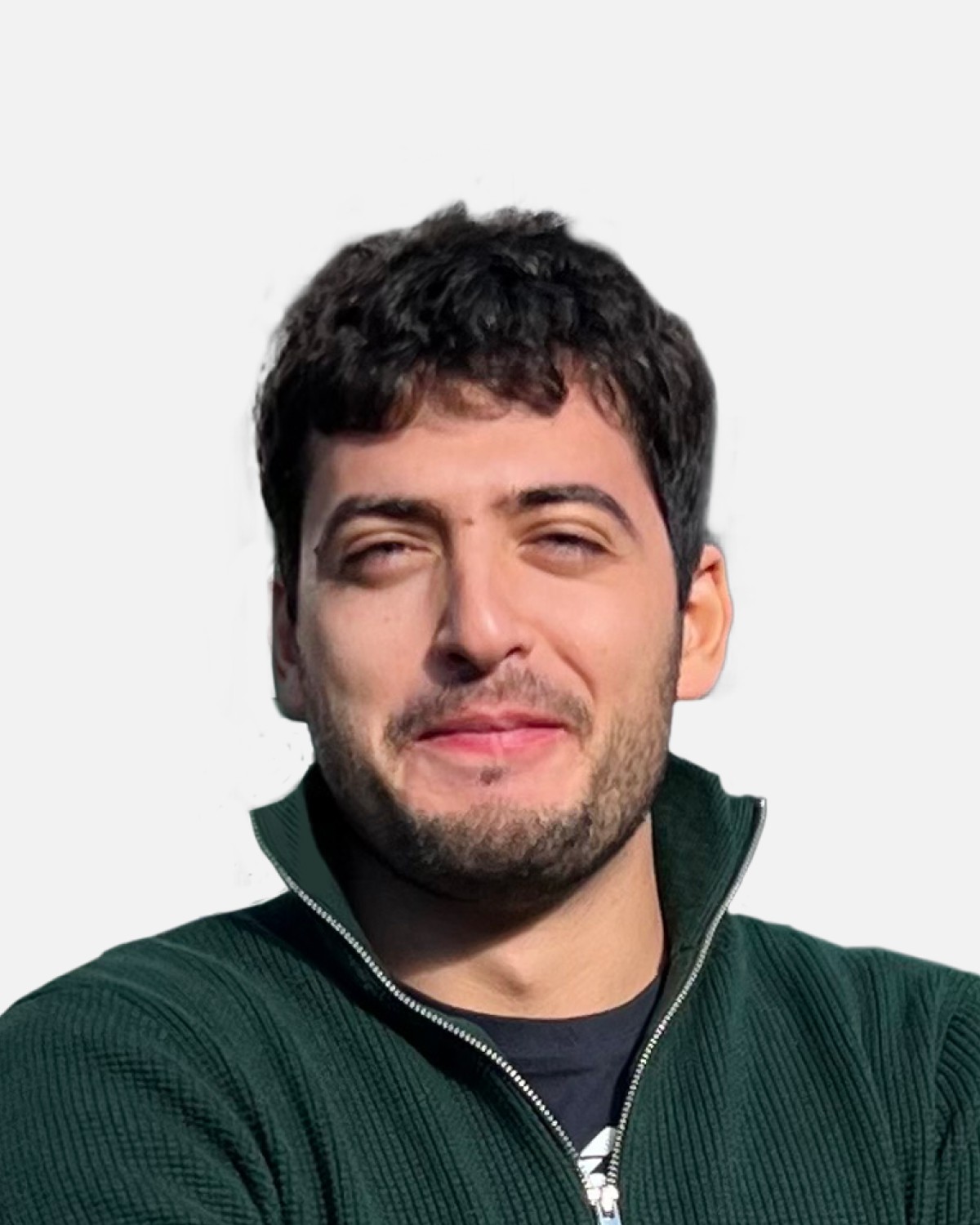 the portrait photo of a young and good-looking man, looking directly to the camera. Man wears green sweather and has dark curly hair