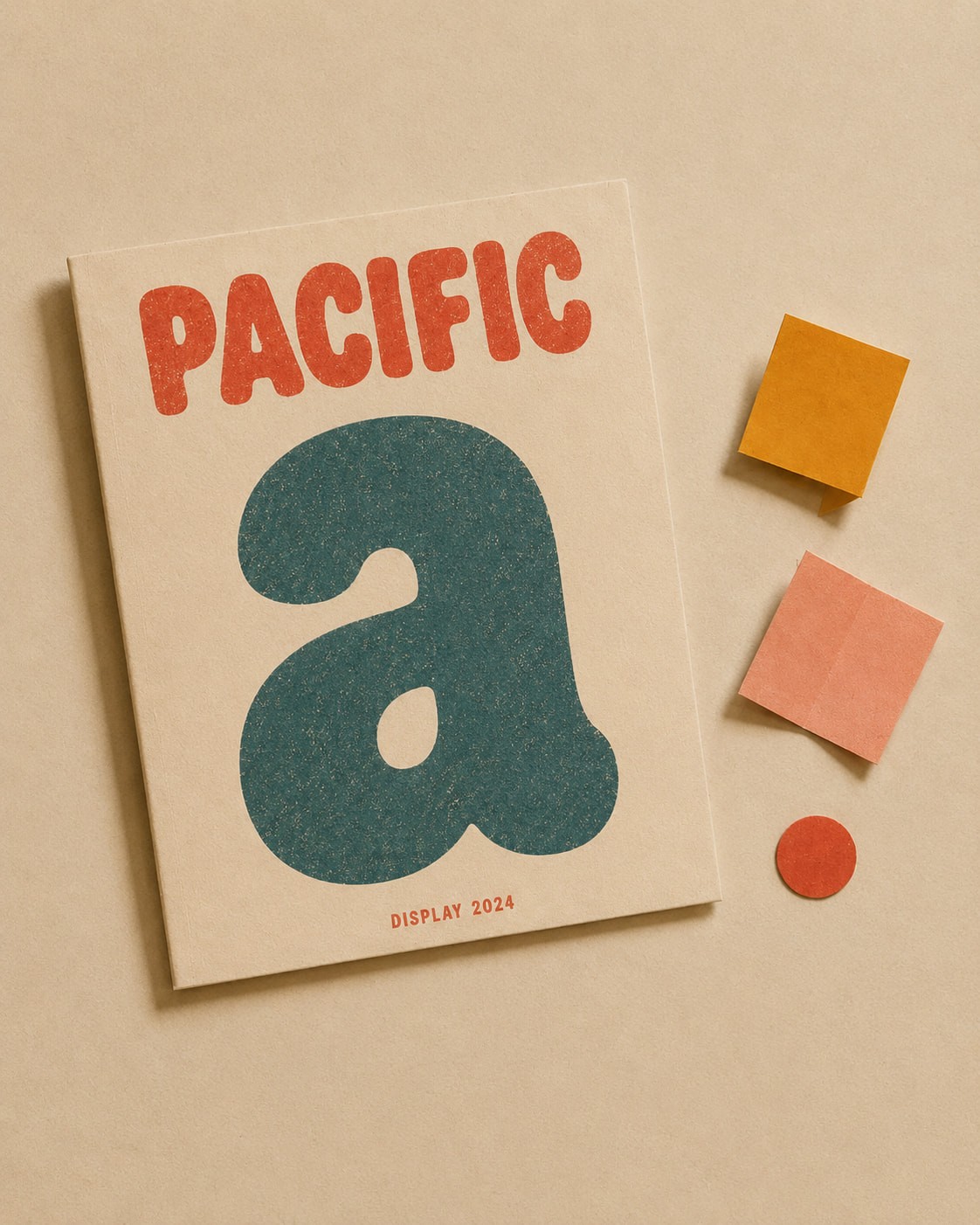 Cover displaying bold "PACIFIC" in red and a large blue lowercase "a" with "DISPLAY 2024" below. Beside it are orange, pink squares, and a red circle on a beige background.