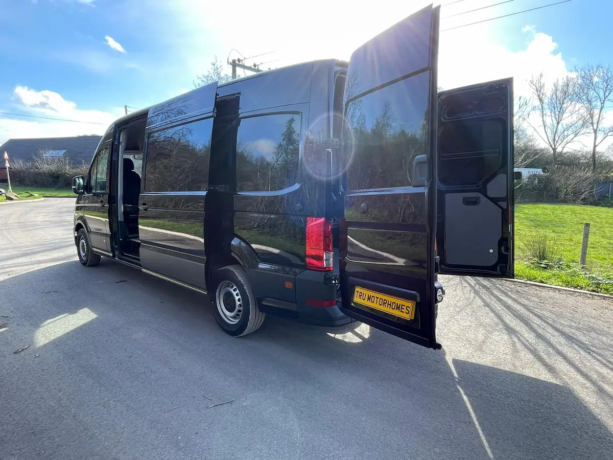 2026 MAN TGE 3.180 4x4 LWB rear doors open showing full-length blank load area ready for camper conversion