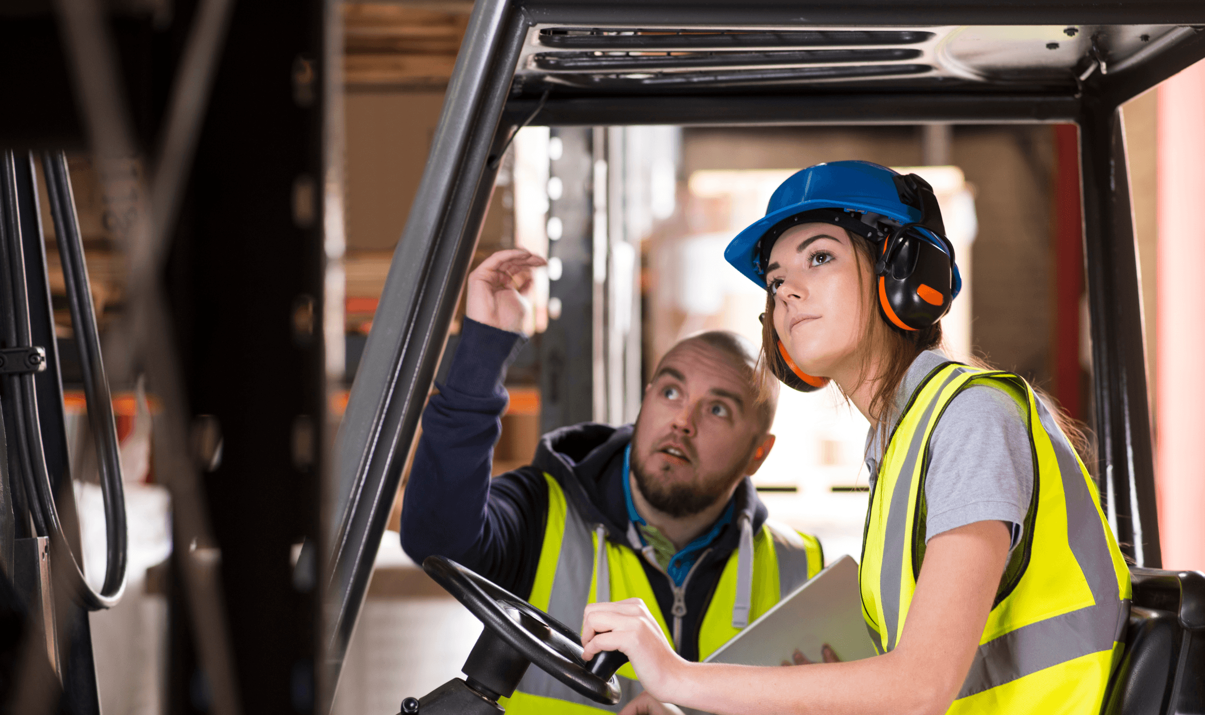 forklift training instructor providing guidance to a student