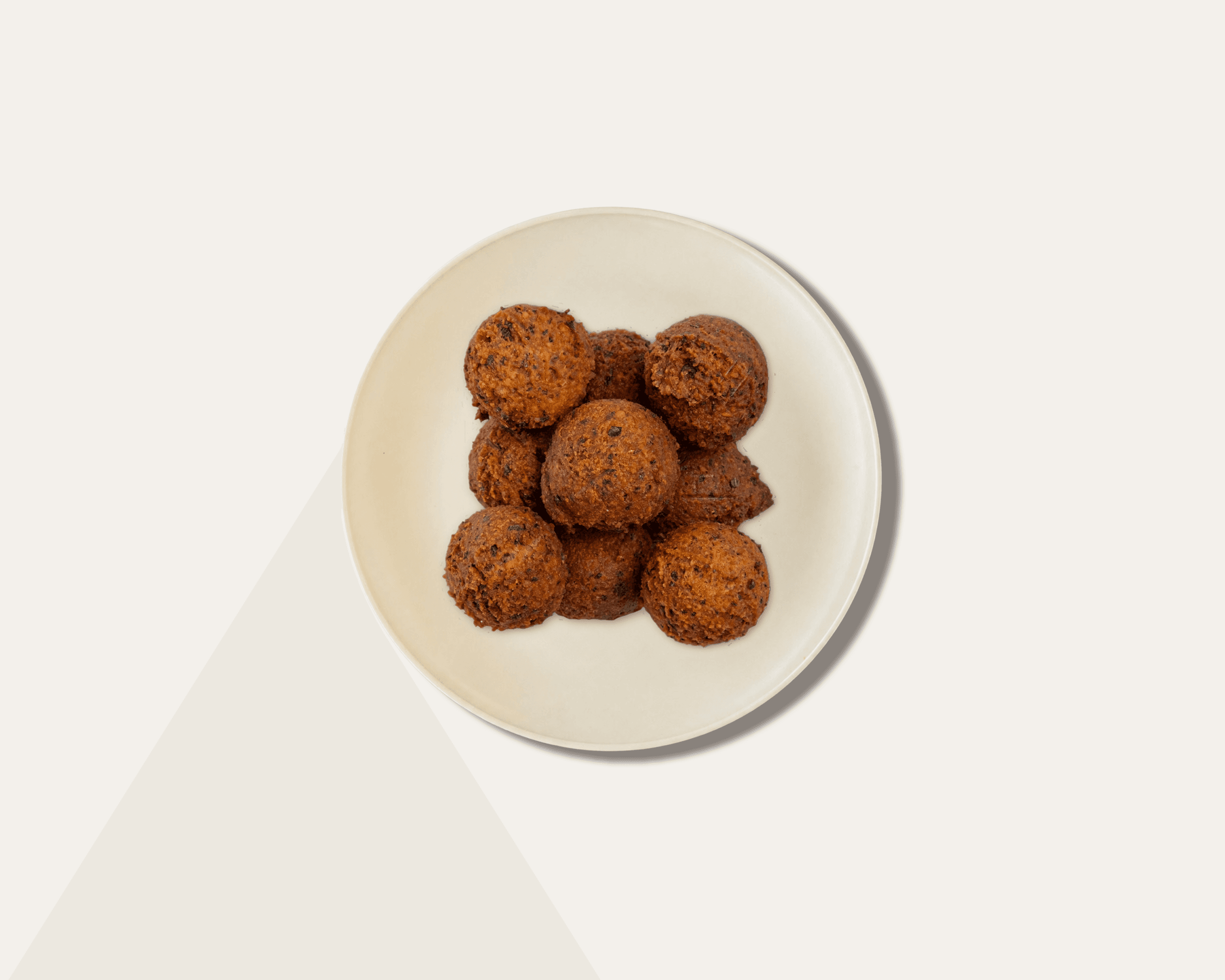 top down shot of a plastic container with falafel balls