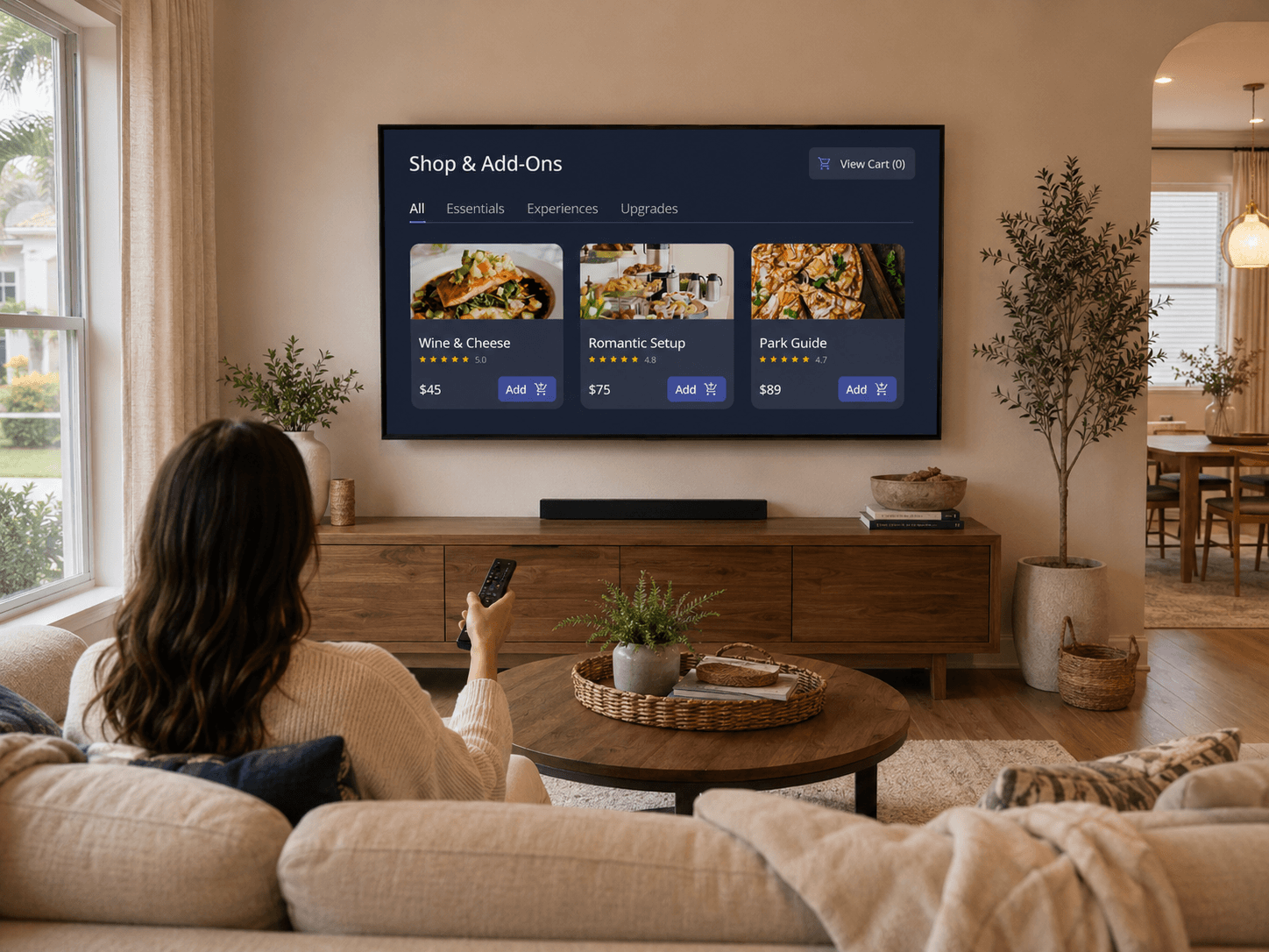 Guest using a remote control to browse shop add-ons and experiences on a smart TV inside a vacation rental living room.