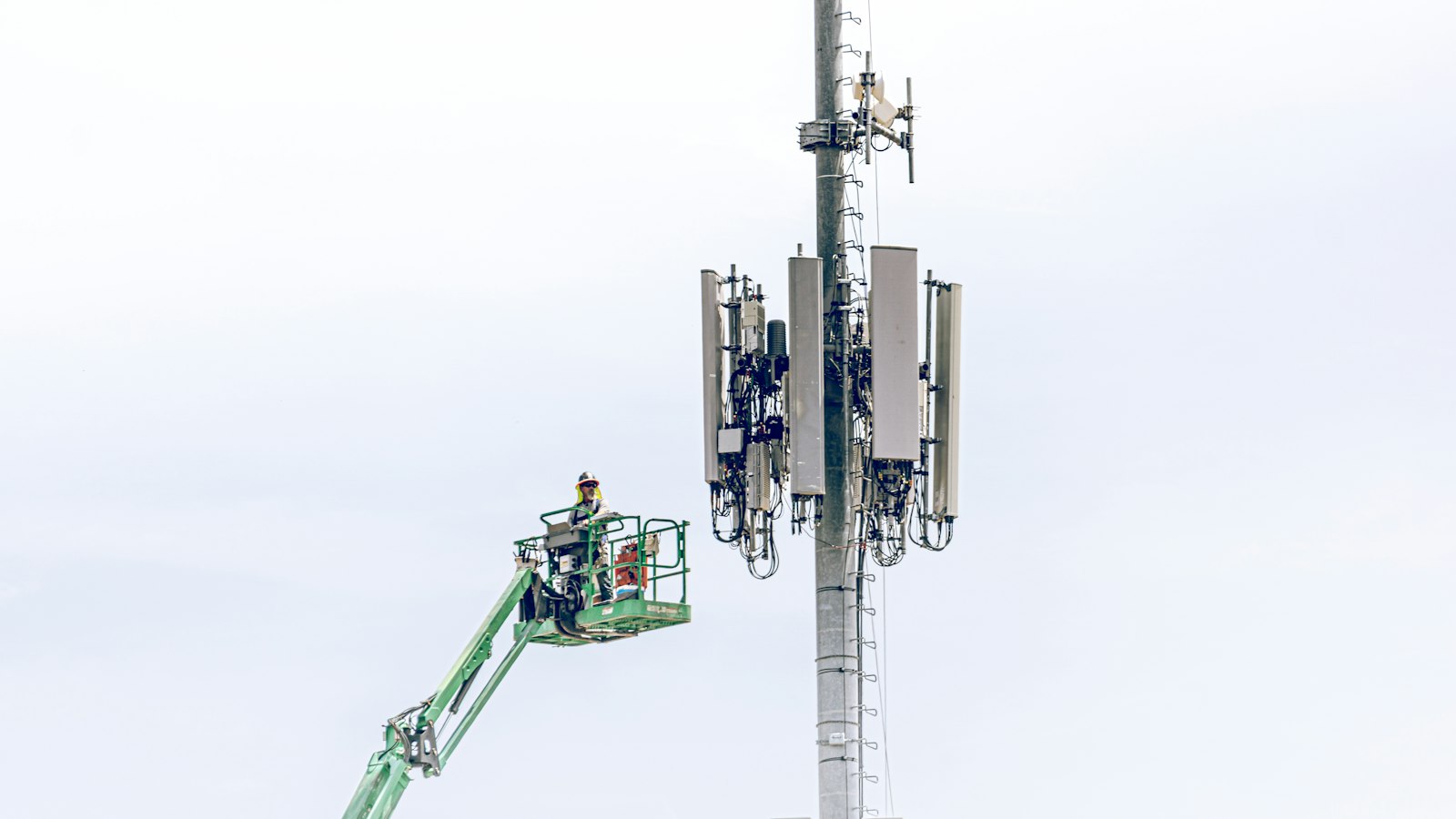 Technician on a lift working on a cell tower