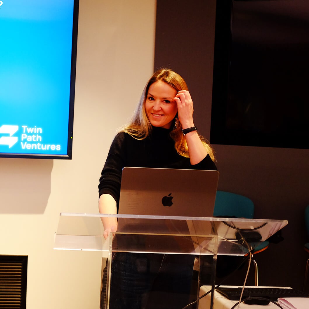 Katie Lockwood presenting at an investor event, sharing insights on early-stage AI startups and innovative product development.