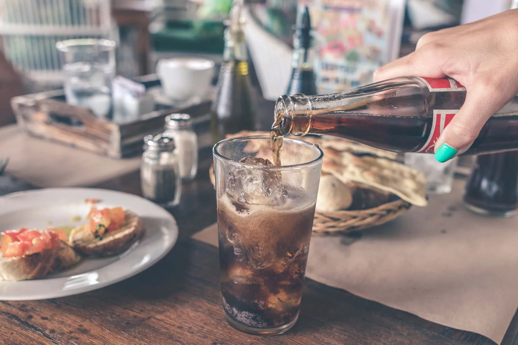 a glass being filled with sugar soda