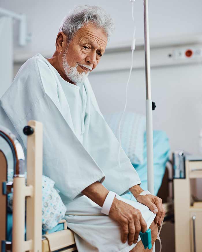 An elderly man in a hospital with unknown sickness