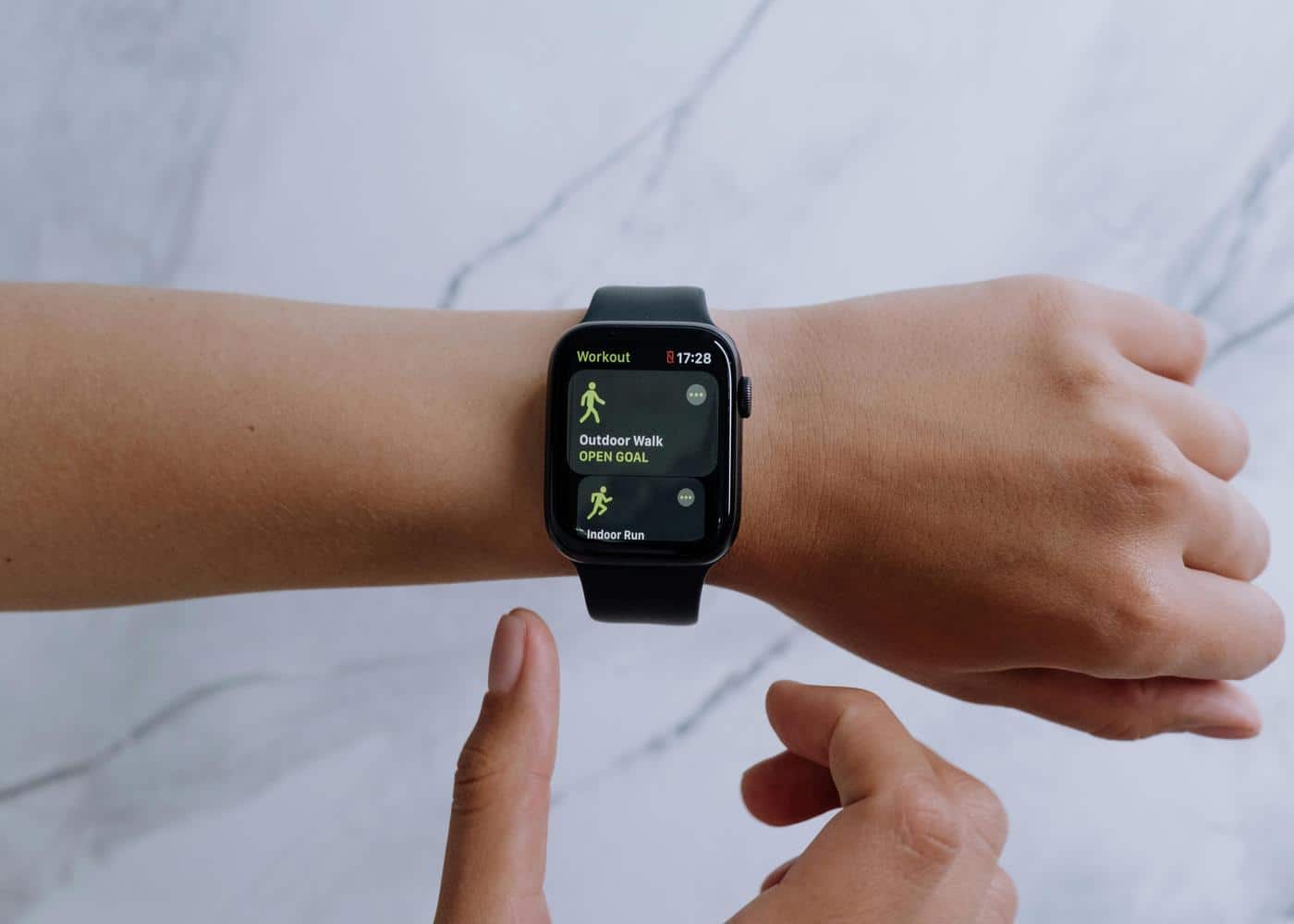 Person wearing Apple Watch looking at workout health app