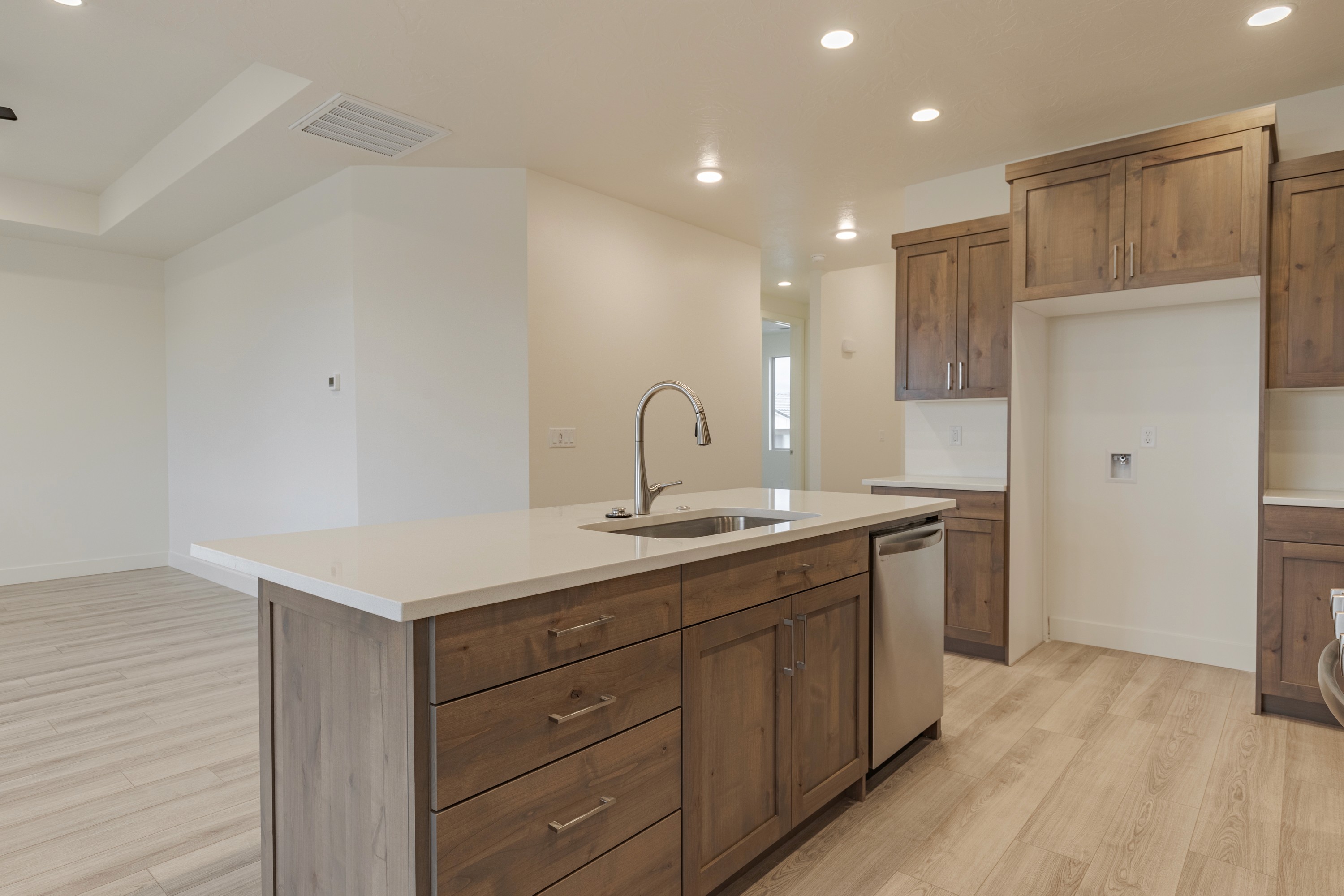 Kitchen inside the Painted Sands twin home in Hurricane, Utah showing cabinetry, countertops, and functional layout.