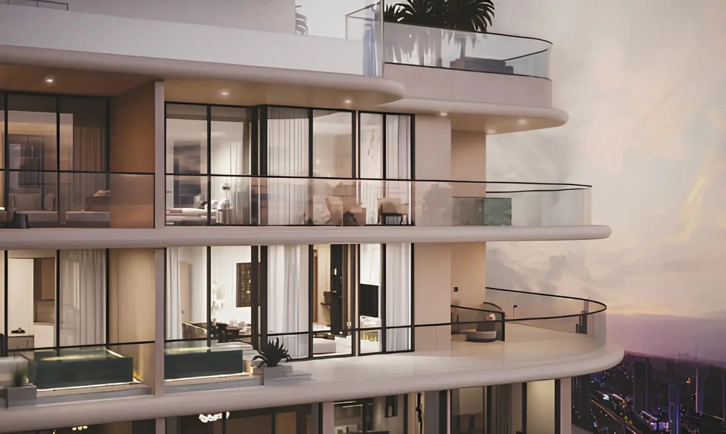 A view of Stax Tower Pasha One, showcasing its elegant glass architecture amidst a vibrant urban environment.