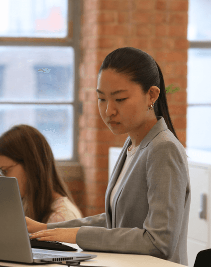 Smiling legal professional in conversation during a meeting, representing collaboration and confidence in a modern legal environment.