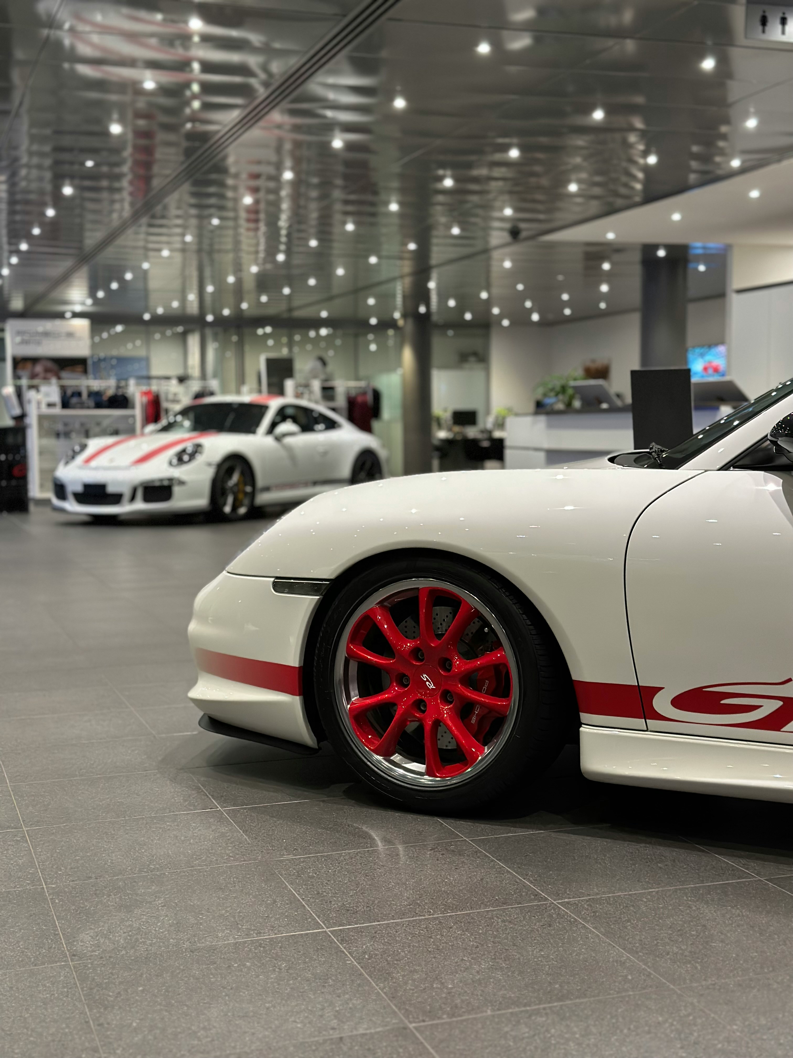 a white sports car parked in a showroom