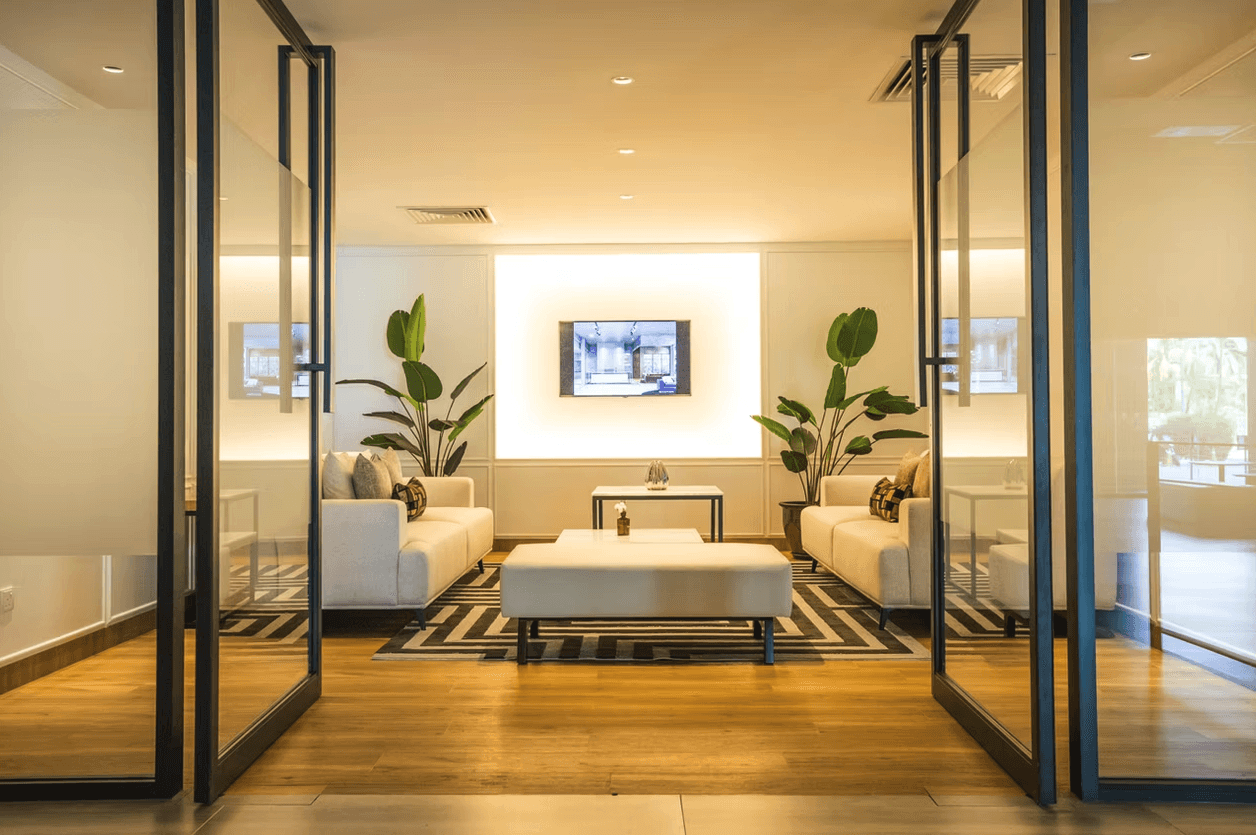 a room with a table, chairs, and a partition