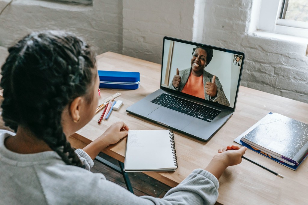 Businesswoman smiling while conducting a virtual interview, reflecting a positive and engaging remote conversation.