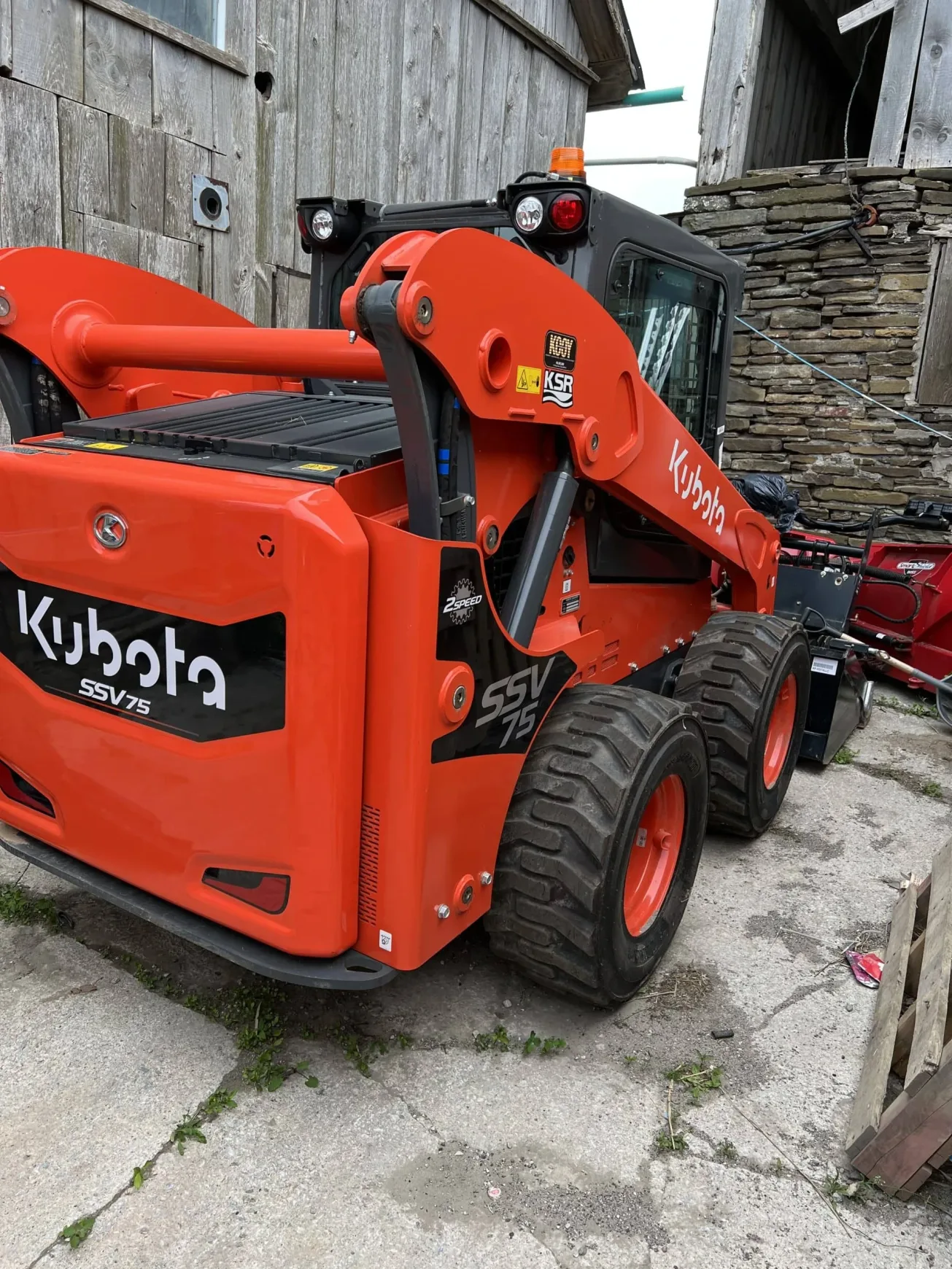 Kubota SSV75 skid steer used by Falcons Landscaping for snow and site maintenance