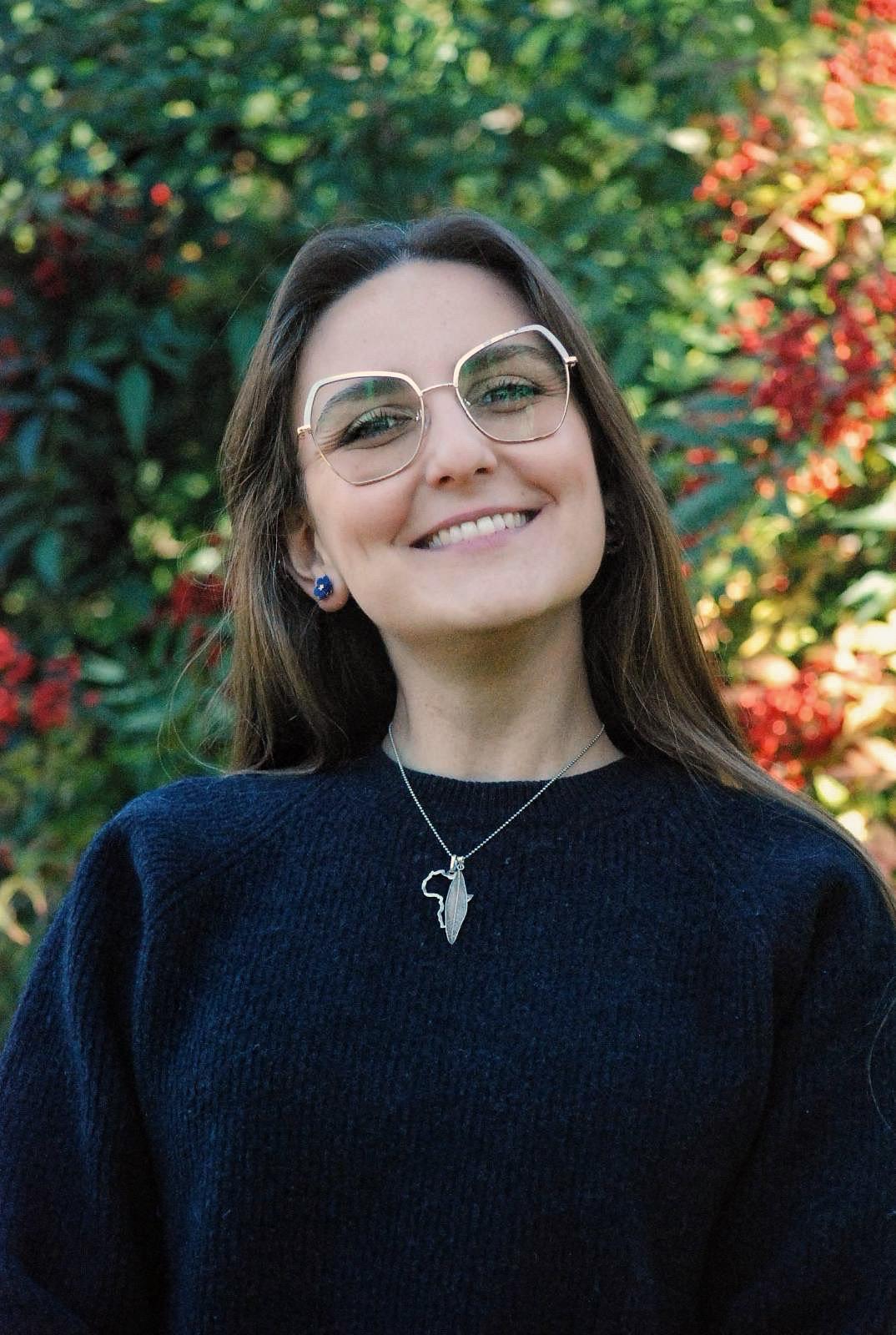 woman in white tank top and black leggings doing yoga during daytime