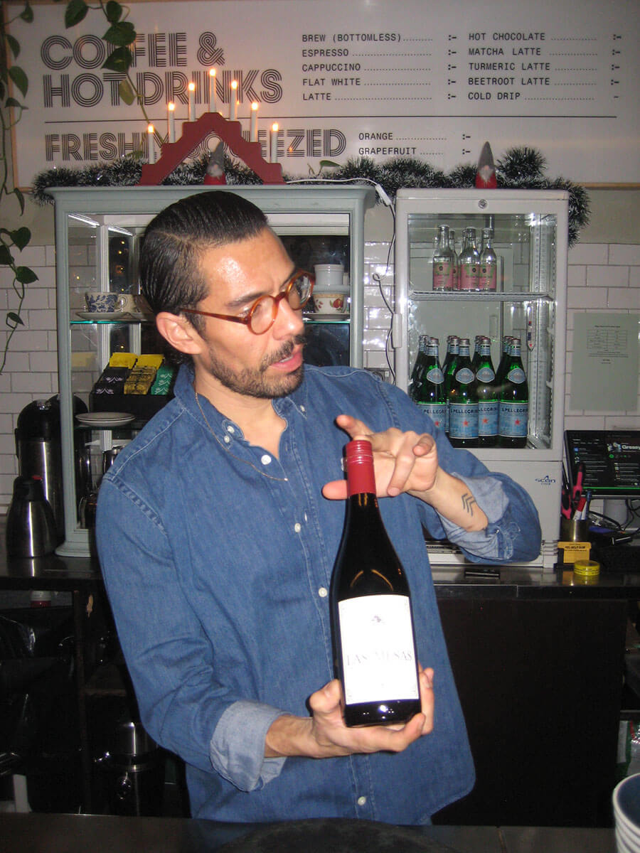 Employee holding a bottle of wine