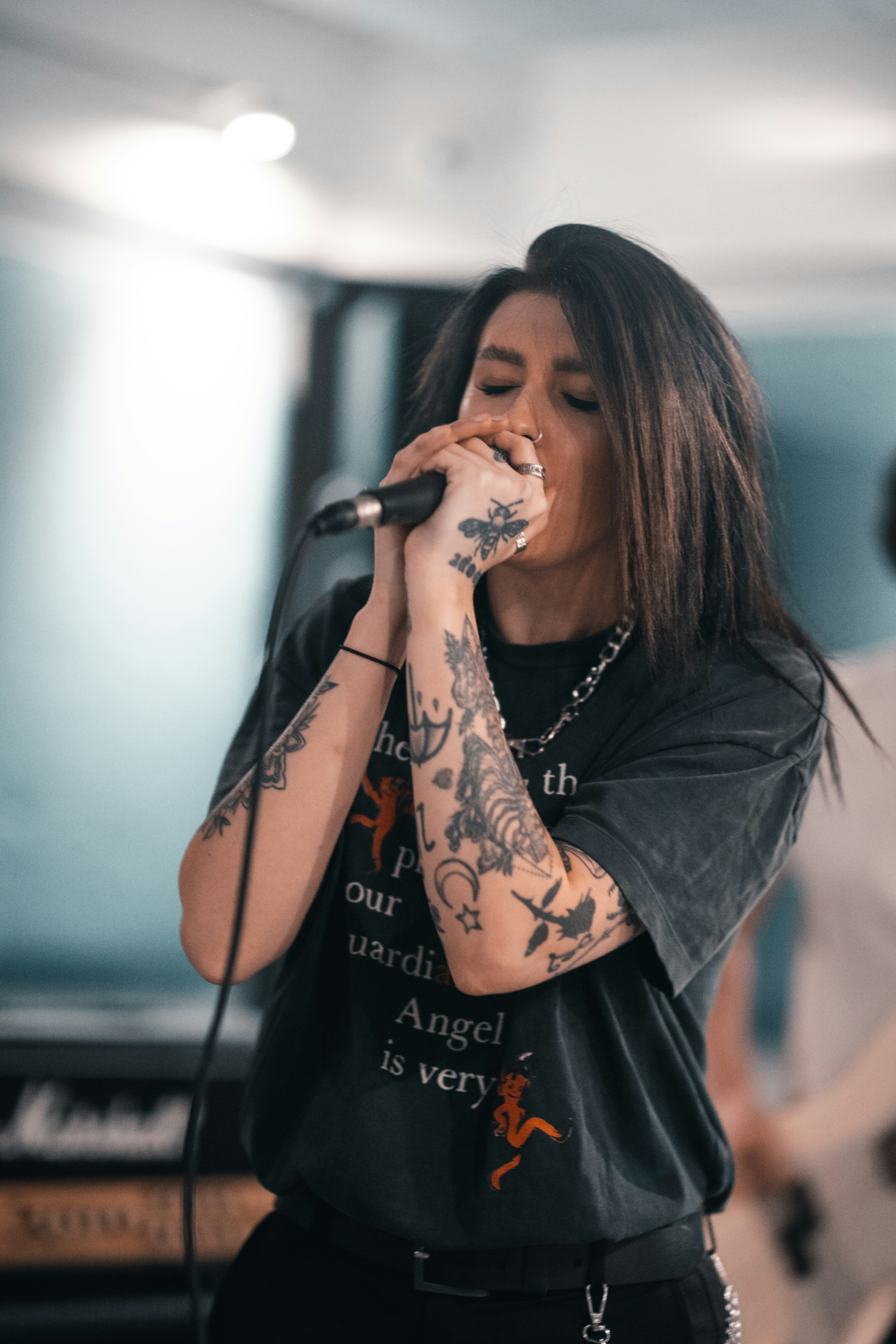 woman in black long sleeve shirt holding microphone