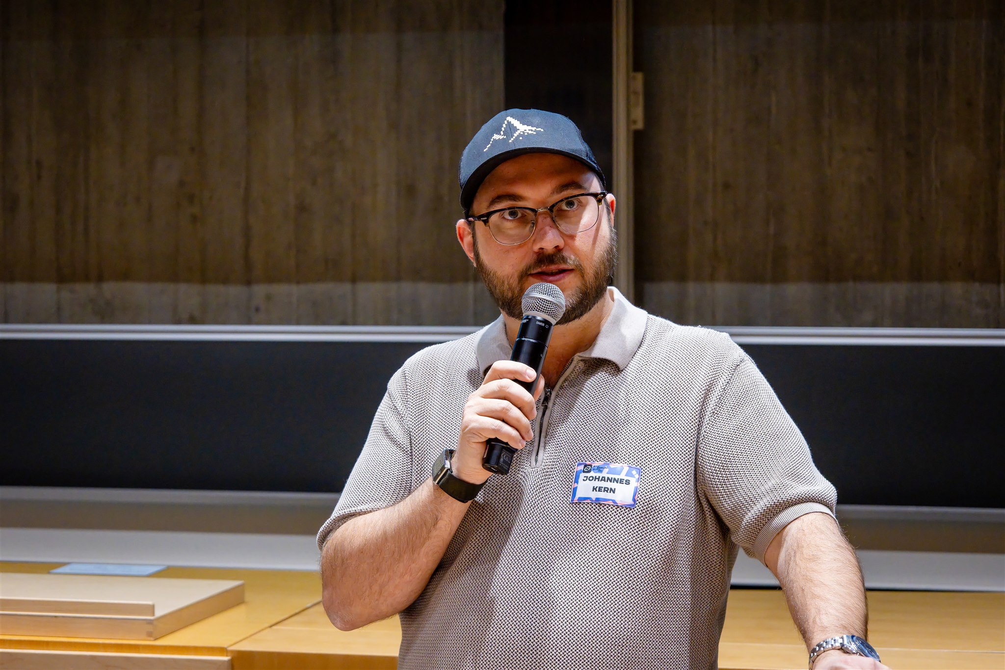 Speaker speaking into microphone during EthereumZüri conference session