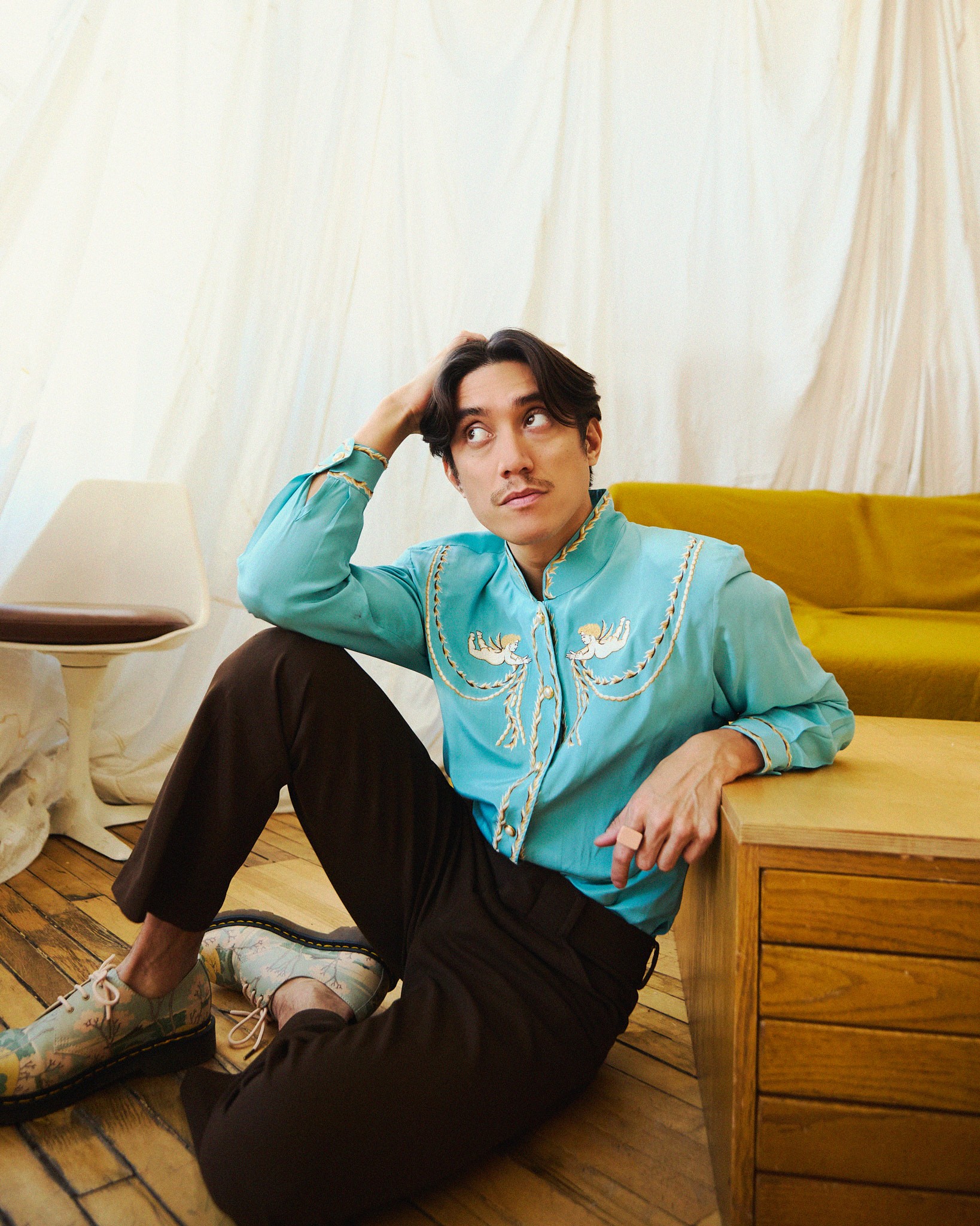 Young woman with dark hair and bangs, wearing red.