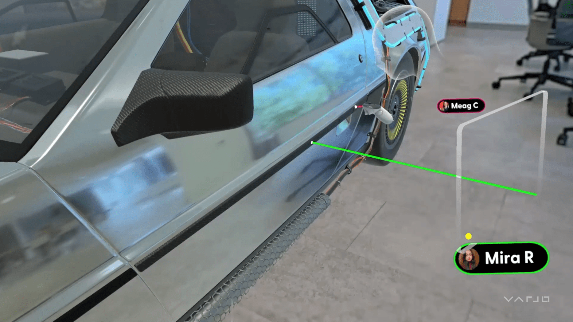 Two users collaborating virtually on a 3D model of a car in mixed reality