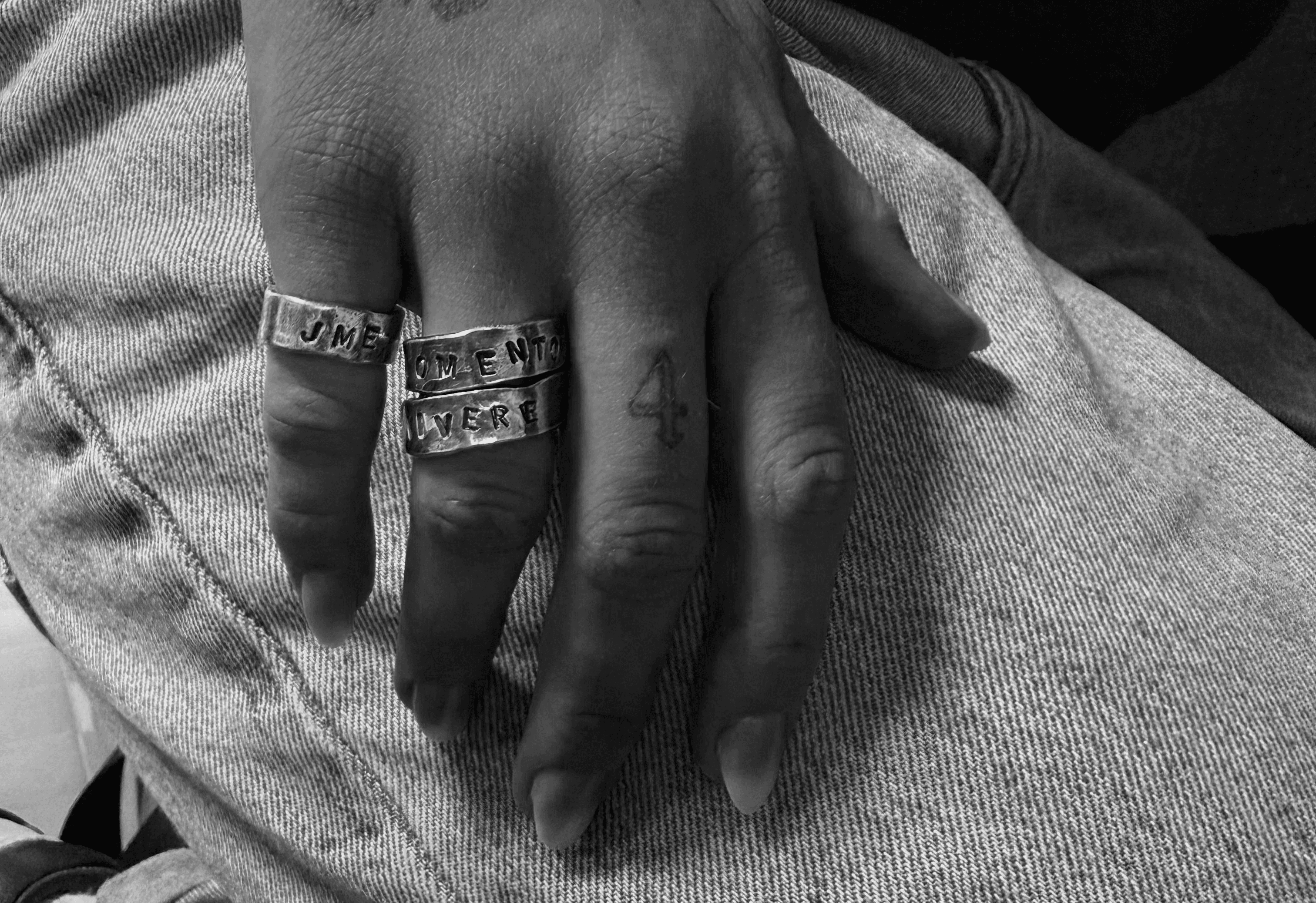 A close-up of a pink cocktail in a martini glass, set against a nighttime background with soft, blurred colors.