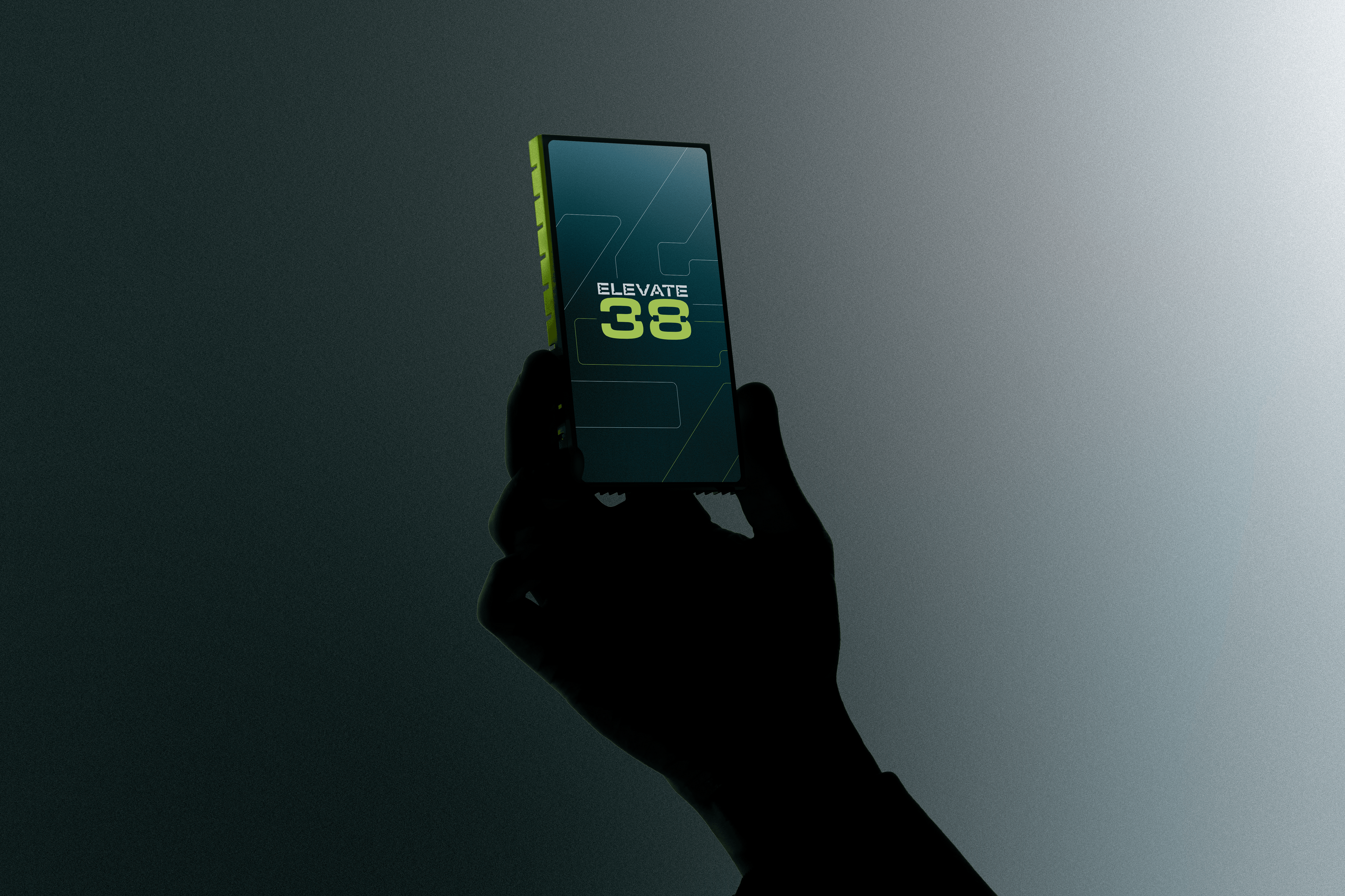 Close-up portrait of a person wearing a gray insulated hooded jacket with the hood up, showing their face framed by the hood against a light background.