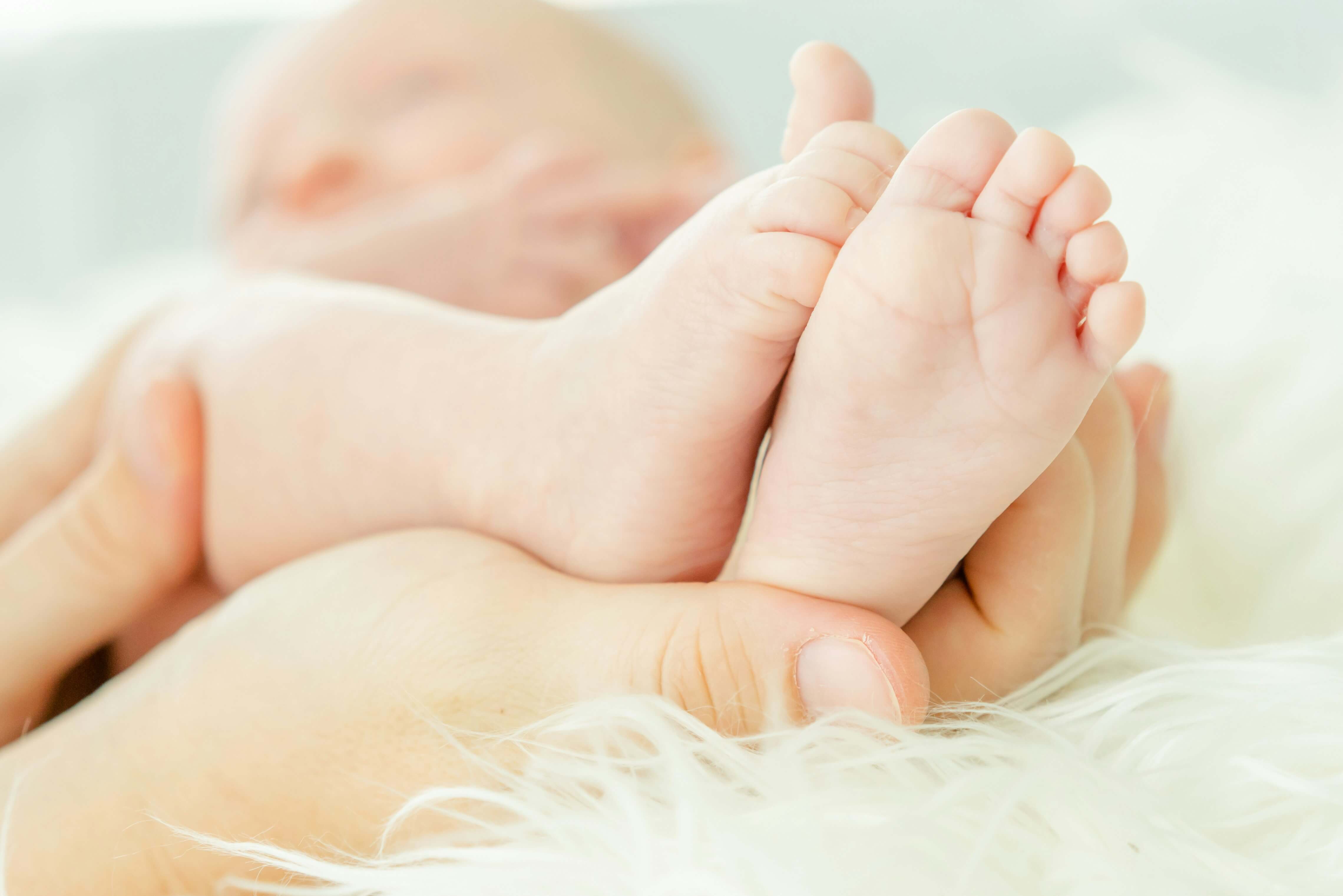 Baby's feet held in parents hands