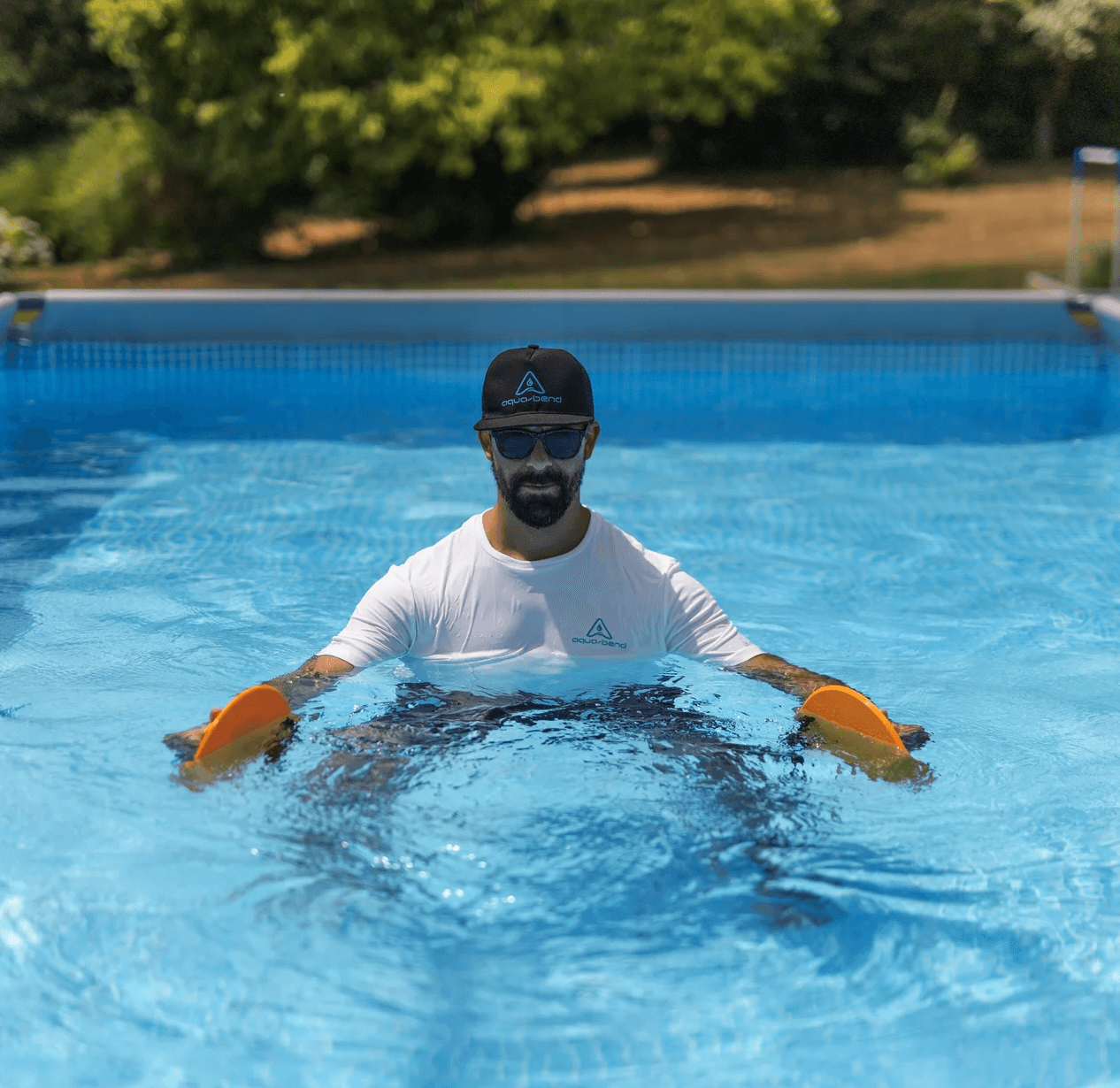 Man performing chest butterfly exercise in water with Aqua-Bend FLEX discs