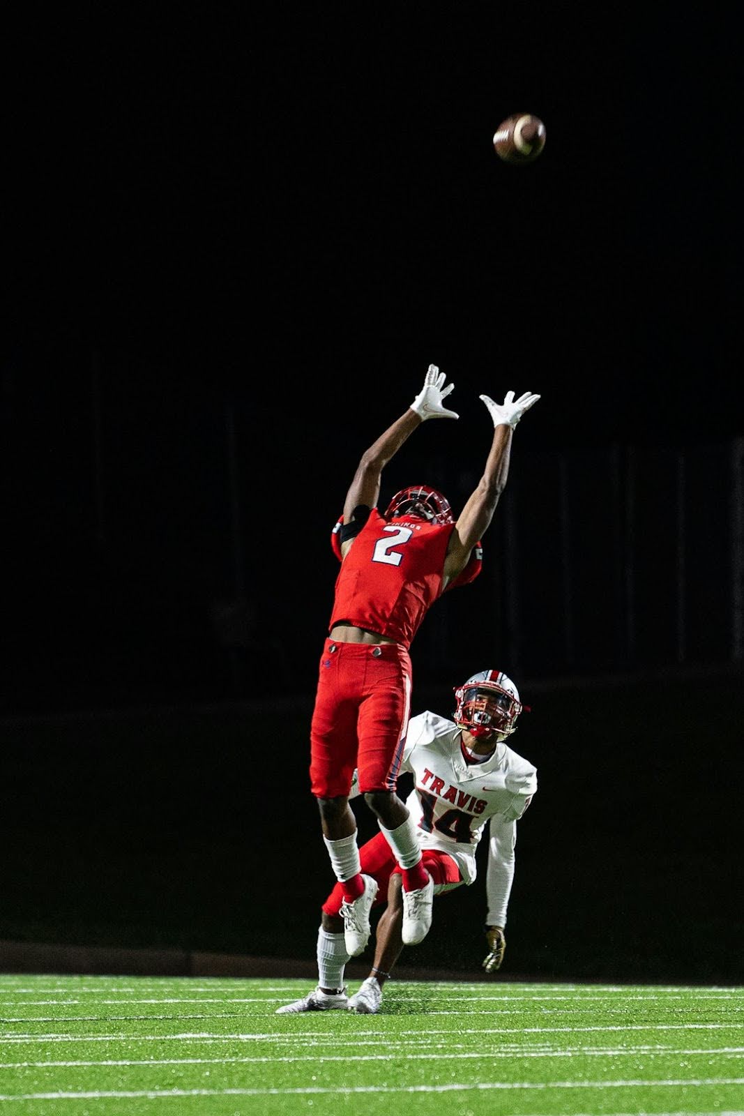 A football player skillfully catches a ball during a game, reminiscent of Joe Namath's iconic Super Bowl III guarantee.