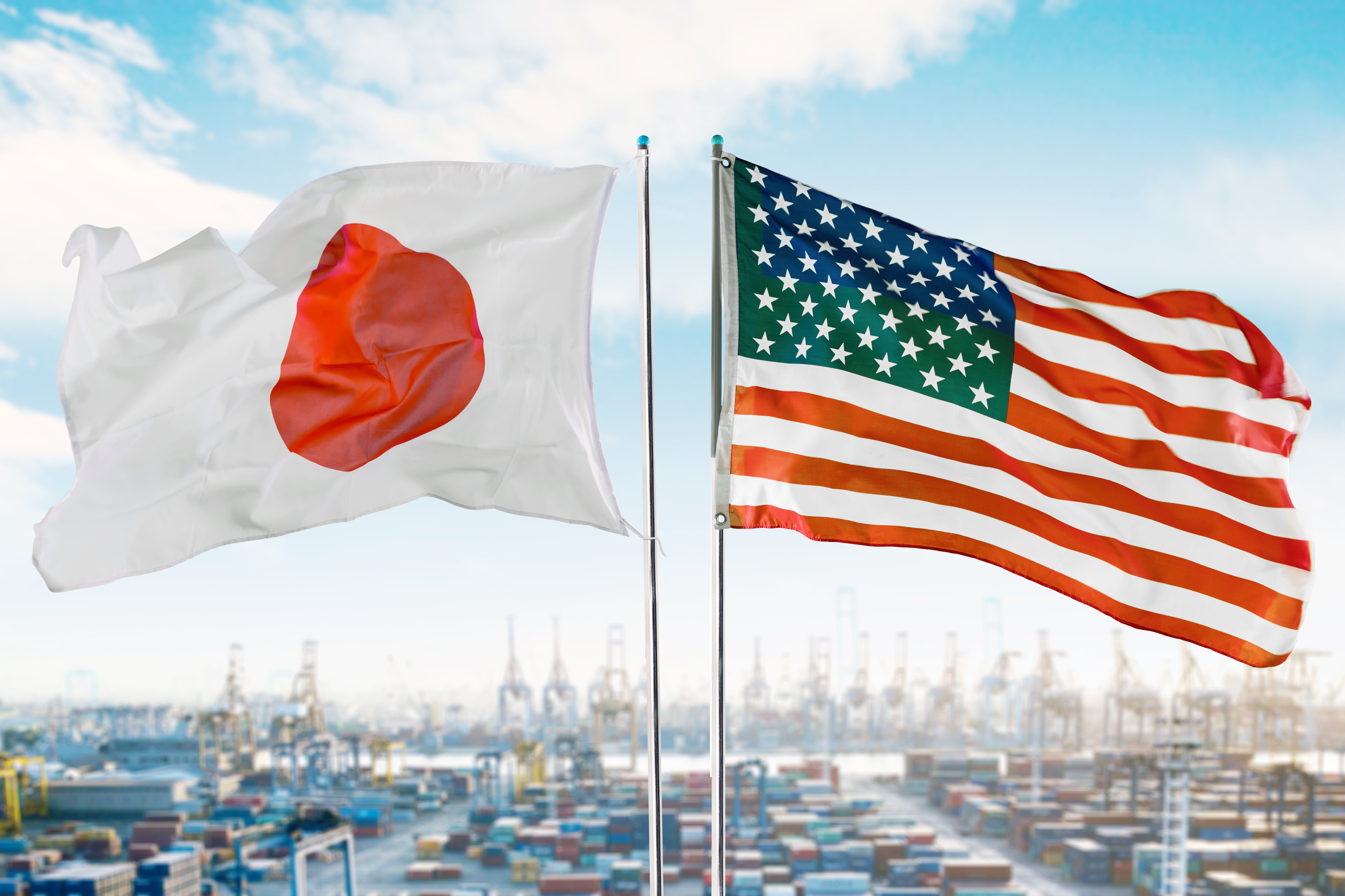 The US and Japanese flag are shown side by side with a port in the background