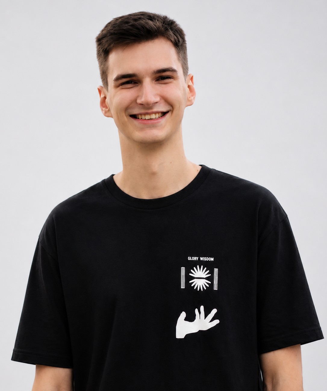 Portrait of a laughing person with curly hair wearing a white shirt