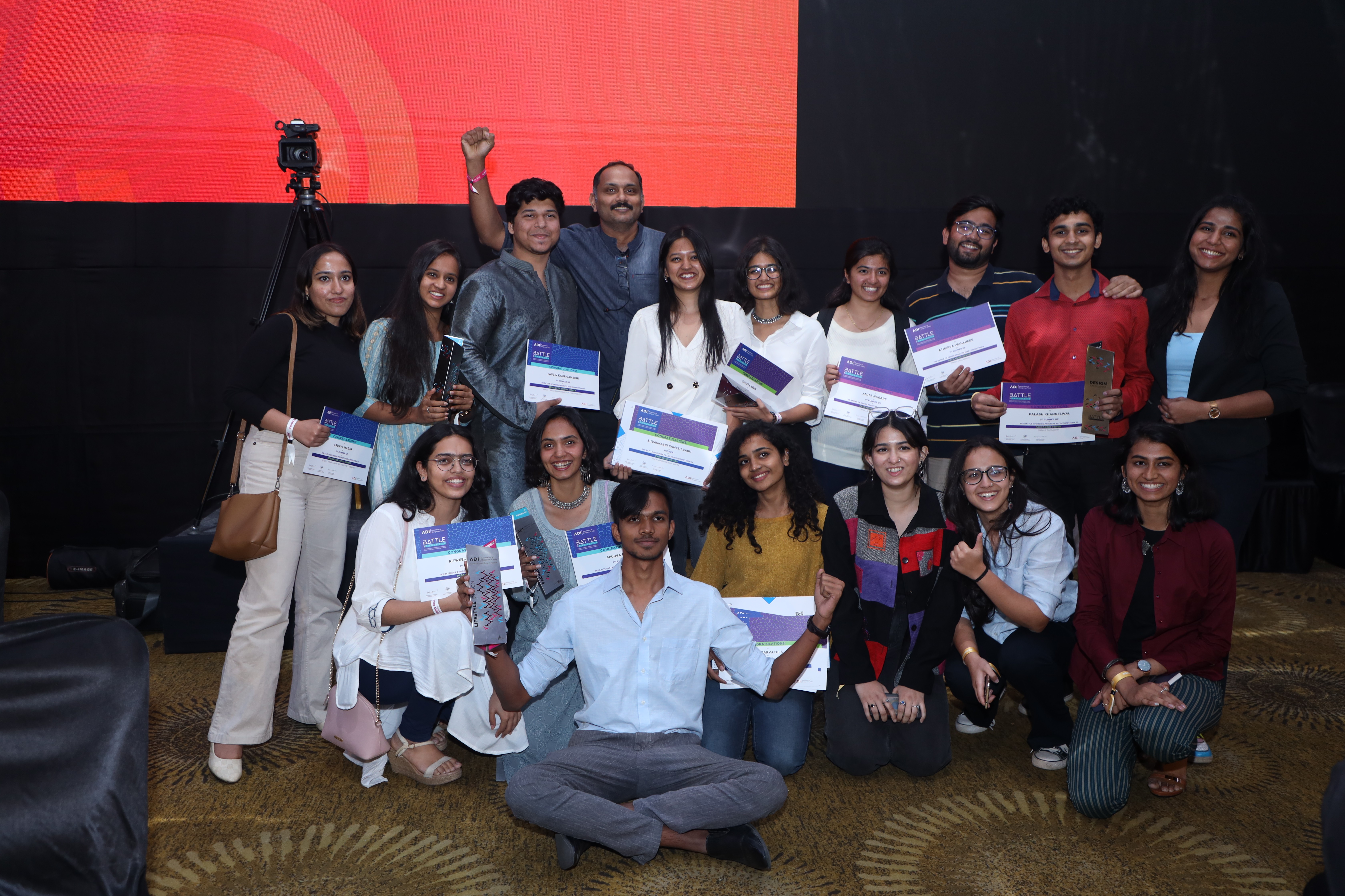person discussing while standing in front of a large screen in front of people inside dim-lighted room