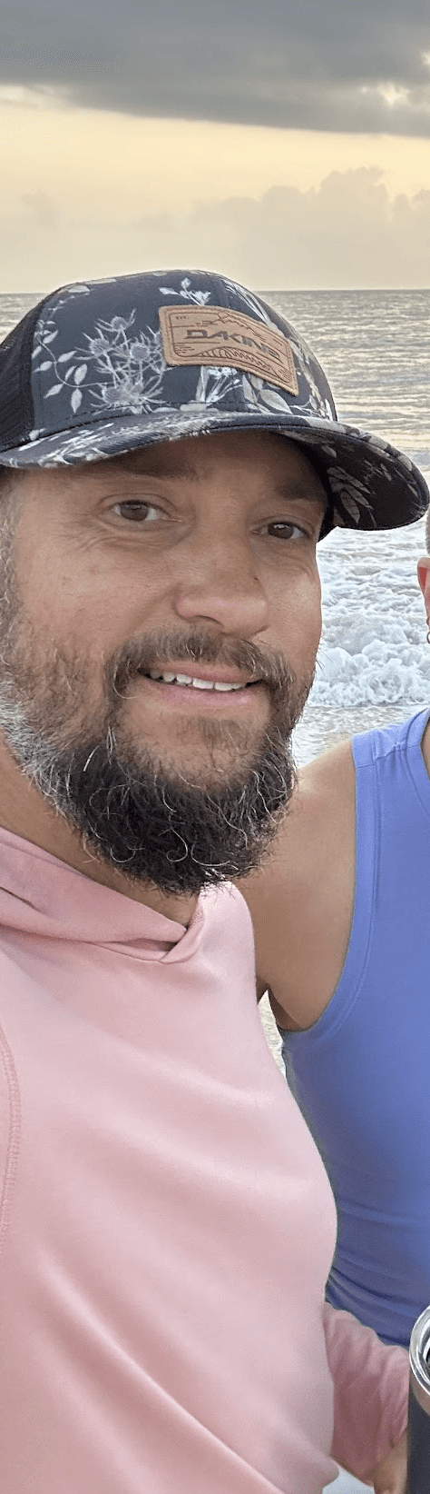 Black and white portrait of a smiling person with curly hair