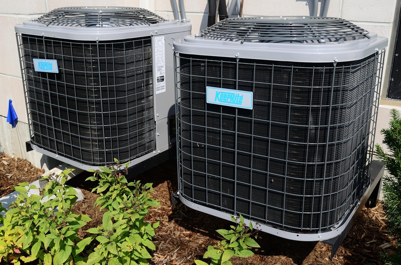 Two Keeprite outdoor air conditioning units installed side by side.