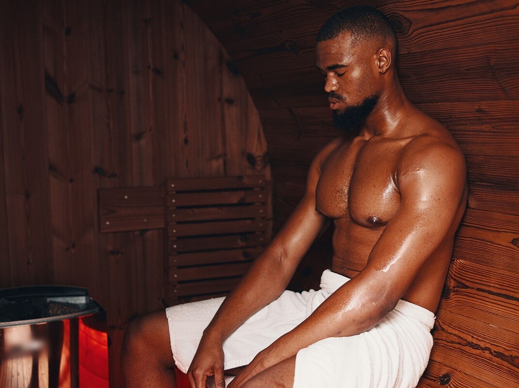 fit man enjoying the benefits of sauna after a weight loss workout for muscle soreness