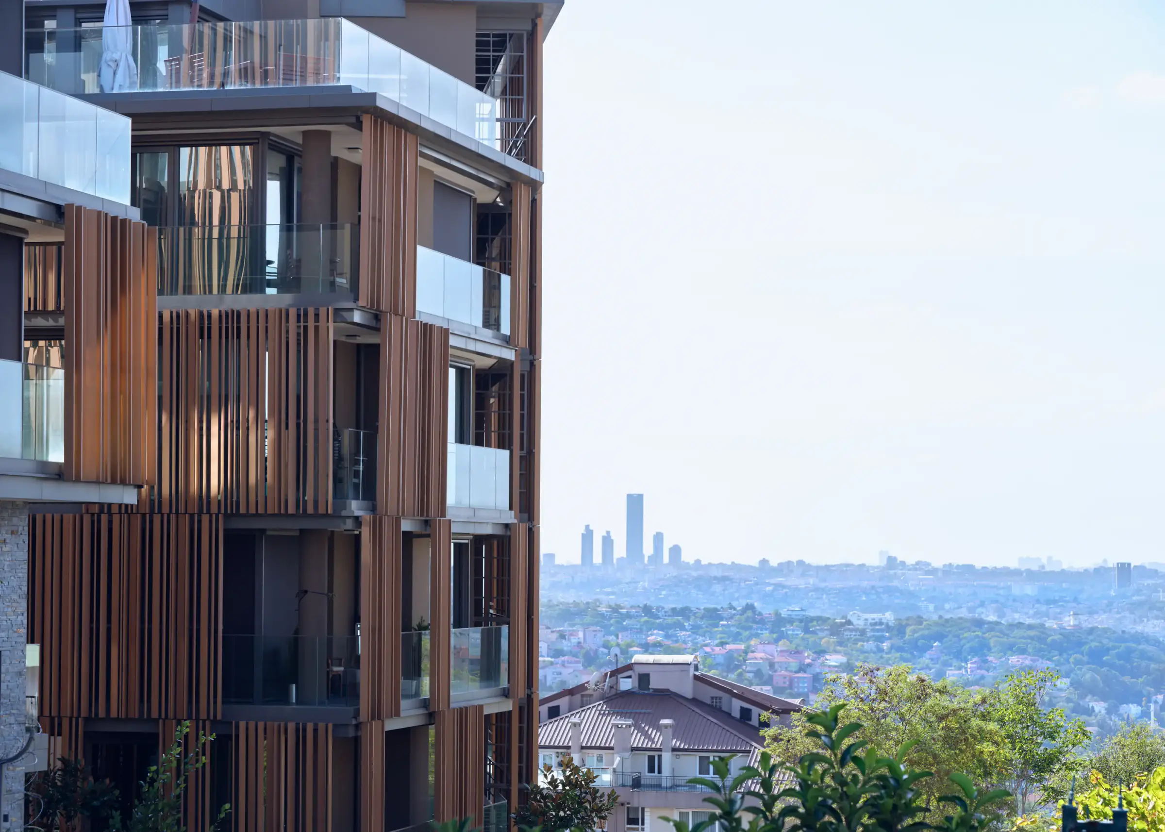 Corner of a timber-louvred block with the city view behind