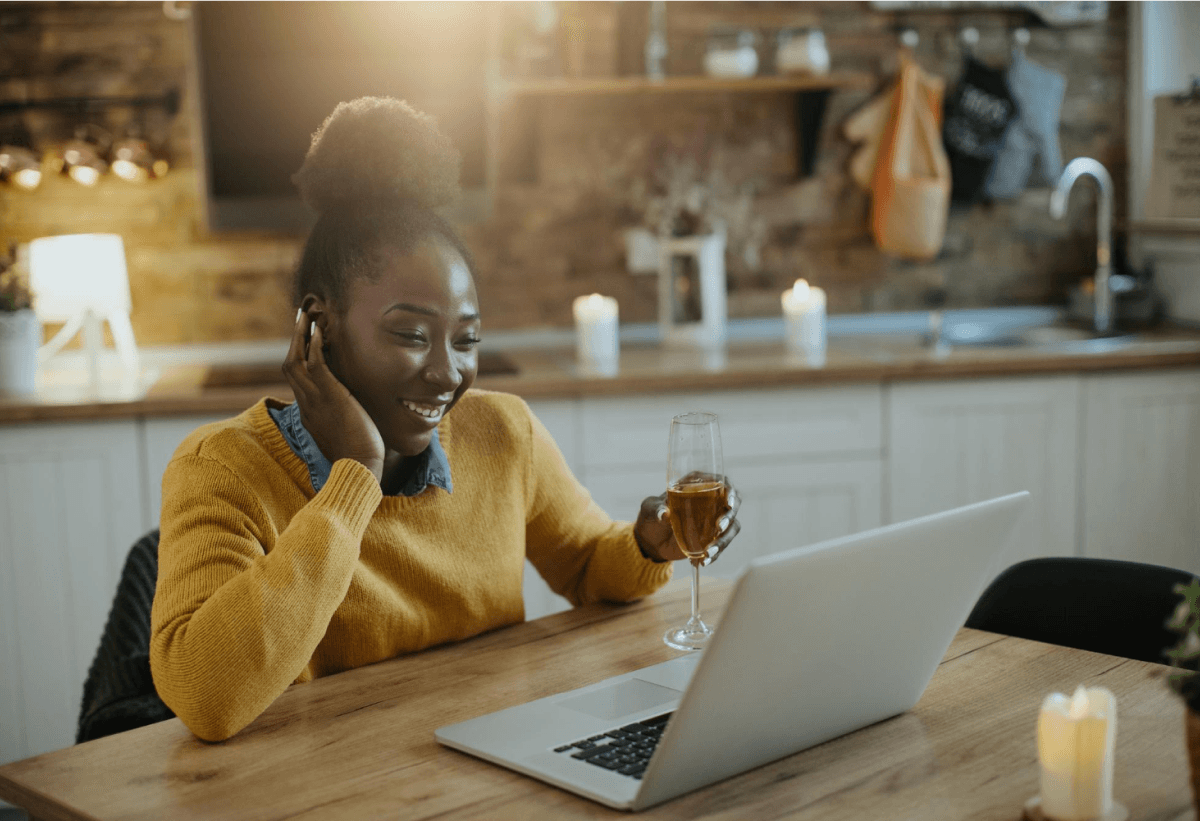 african girl using laptop and talking over phone