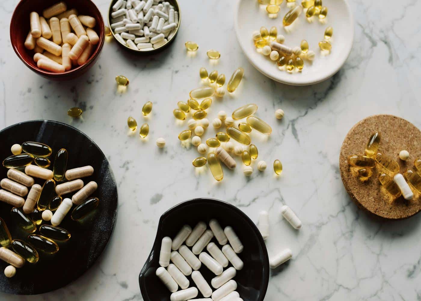 Mixed supplements sitting on various plates and on table