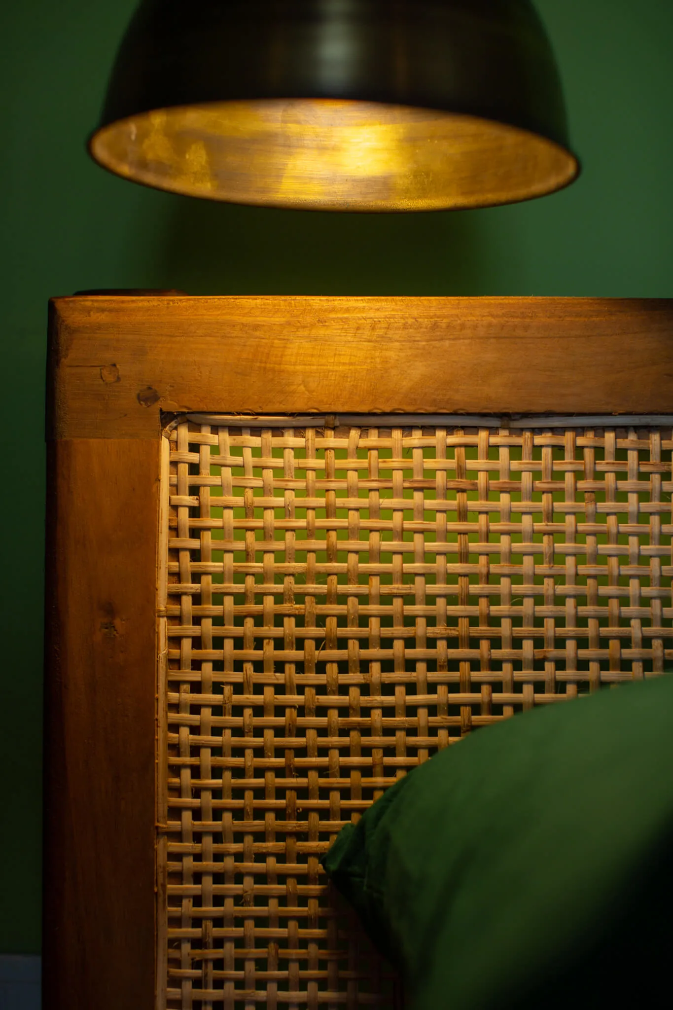 Cane bedhead and brass lamp detail at Casa Jaali