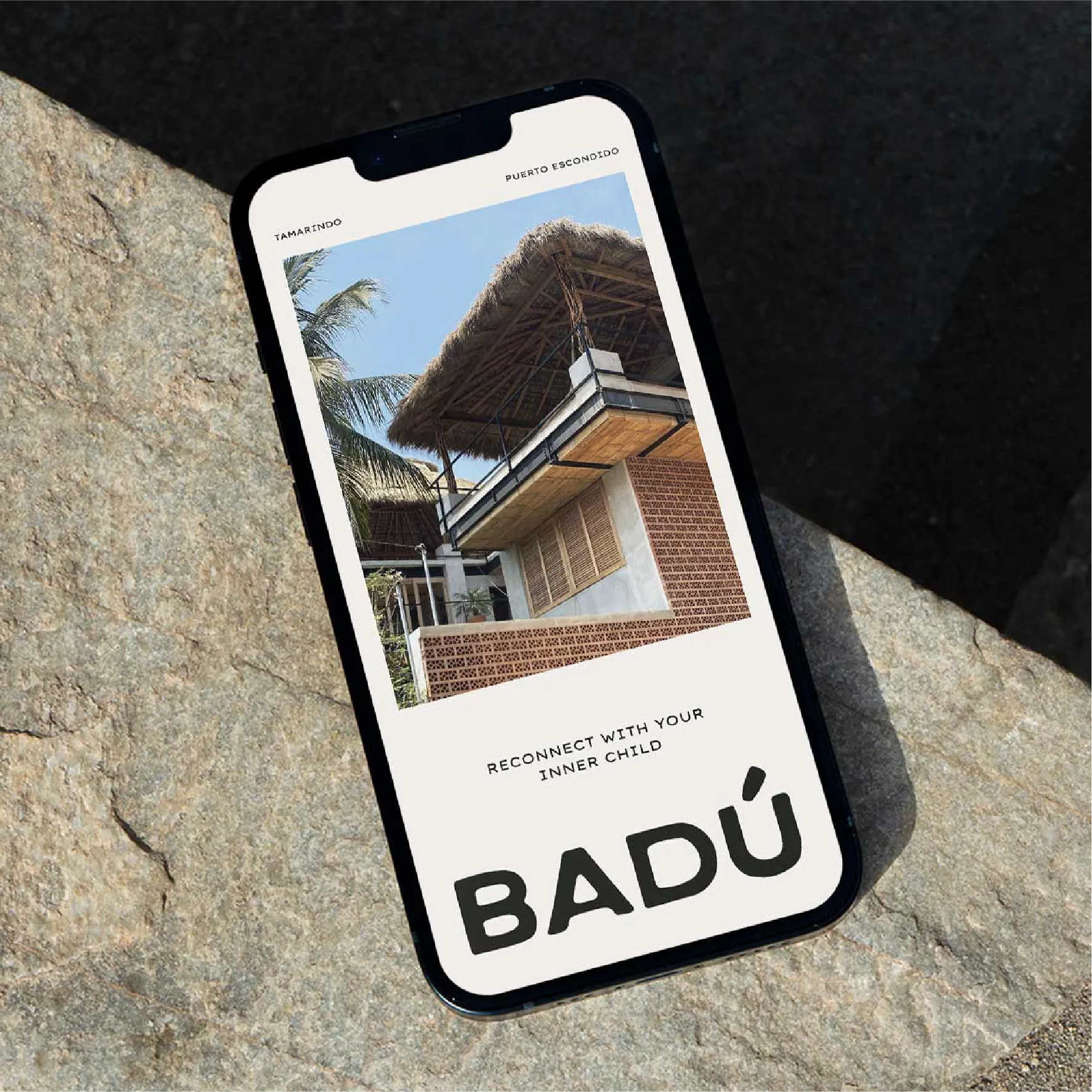 A phone on a stone floor with a badu social post on the screen