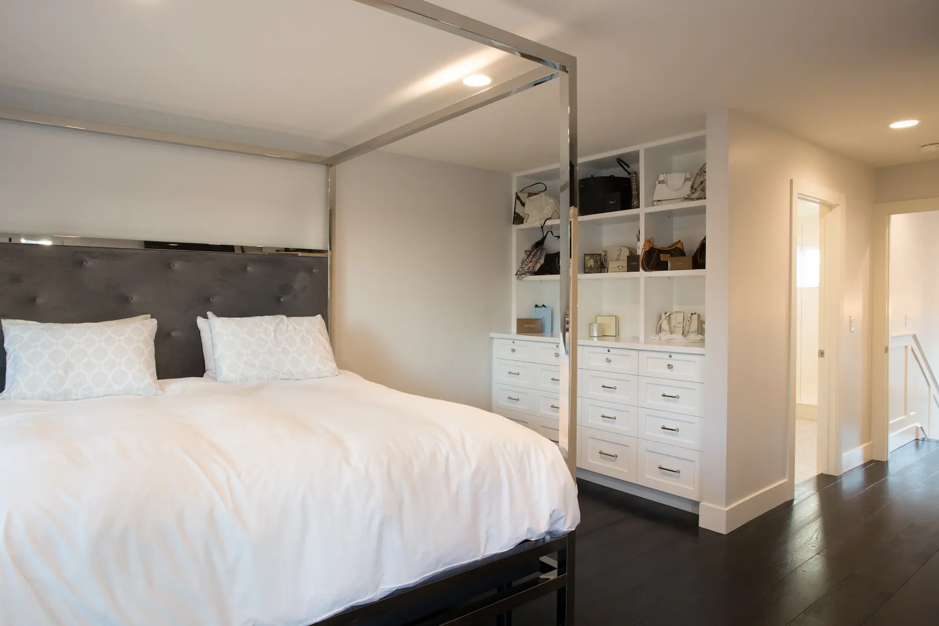 Elegant bedroom with modern chrome bedframe and white buil-in cabinets. From Dana Point Cape Cod remodel, photo by Chris Darnall.