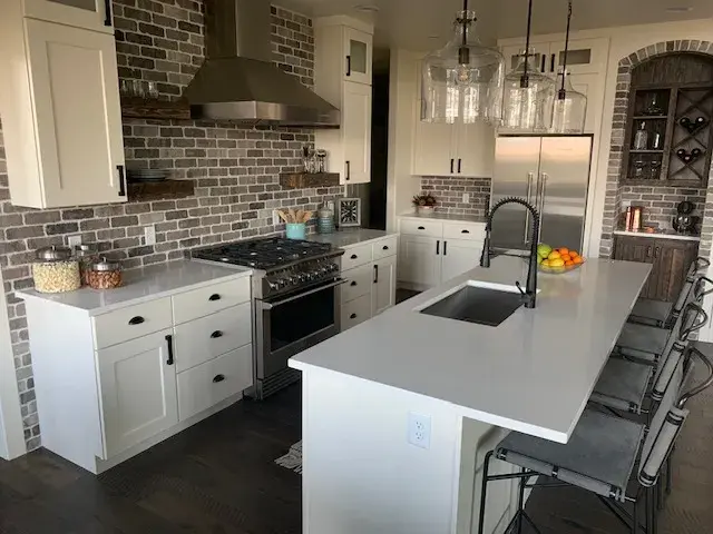 Kitchen with white cabinets and large island
