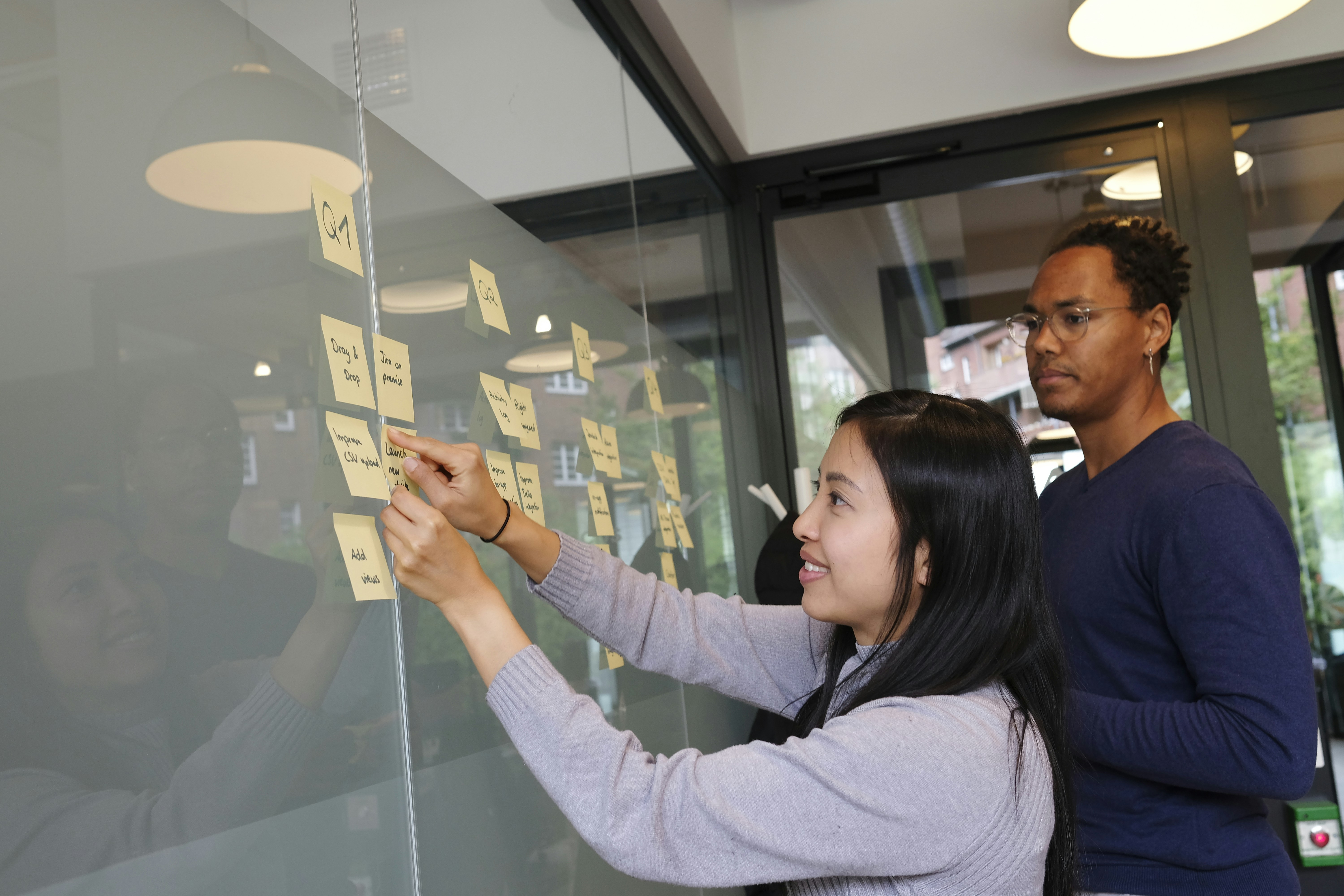 Two People Sorting Out Taks on the Board - Workflowy Alternatives